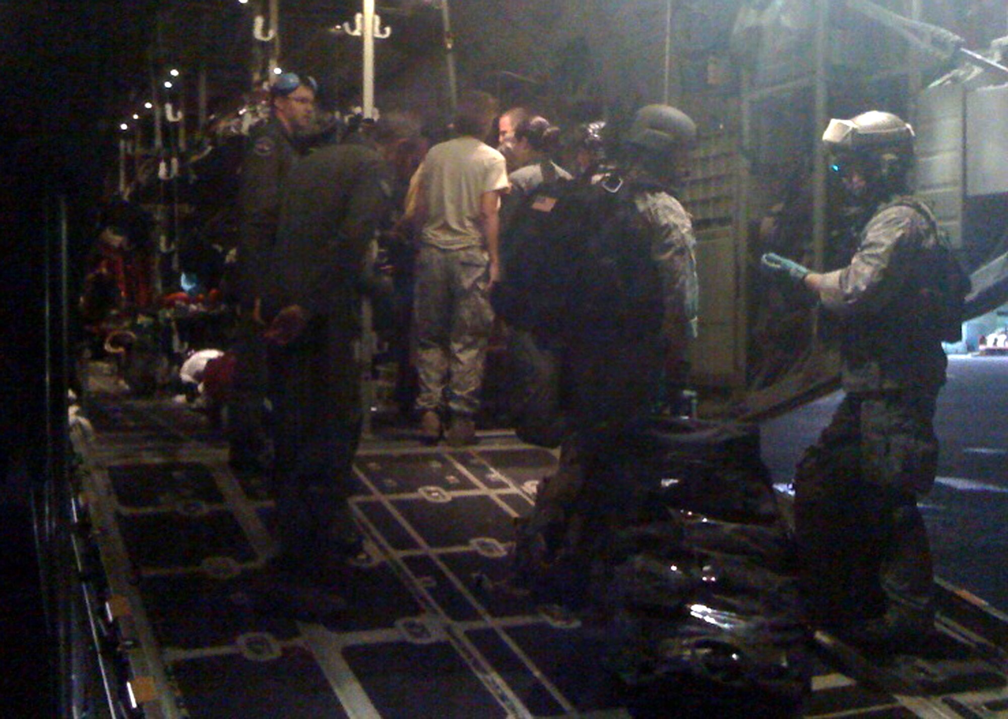 Military medics and C-130 Hercules aircrew members from the Air Force Reserve's 302nd Airlift Wing finalize plans to transport evacuees during the early morning hours of Jan. 17 at Toussaint Louverture International Airport in Port-au-Prince, Haiti. The C-130 aircrew, based at Peterson Air Force Base, Colo., transported the injured Haitians to Fort Lauderdale, Fla., where they received additional medical treatment. (U.S. Air Force photo/Capt. Brian McReynolds)