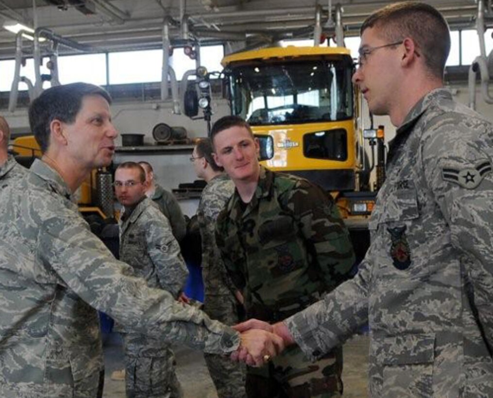 Major Gen. Darrell Jones, Air Force District of Washington commander, greets Airman 1st Class Joseph M. Lewis, 316th Civil Engineer Squadron firefighter, at the snow barn Jan. 7 as part of a familiarization tour of the 316th Wing. General Jones took command of AFDW in November 2009, and before that he was the director of Force Management Policy, deputy chief of staff for Manpower and Personnel, Headquarters U.S. Air Force, Washington, D.C. (U.S. Air Force photo by Airman 1st Class Melissa Rodrigues)