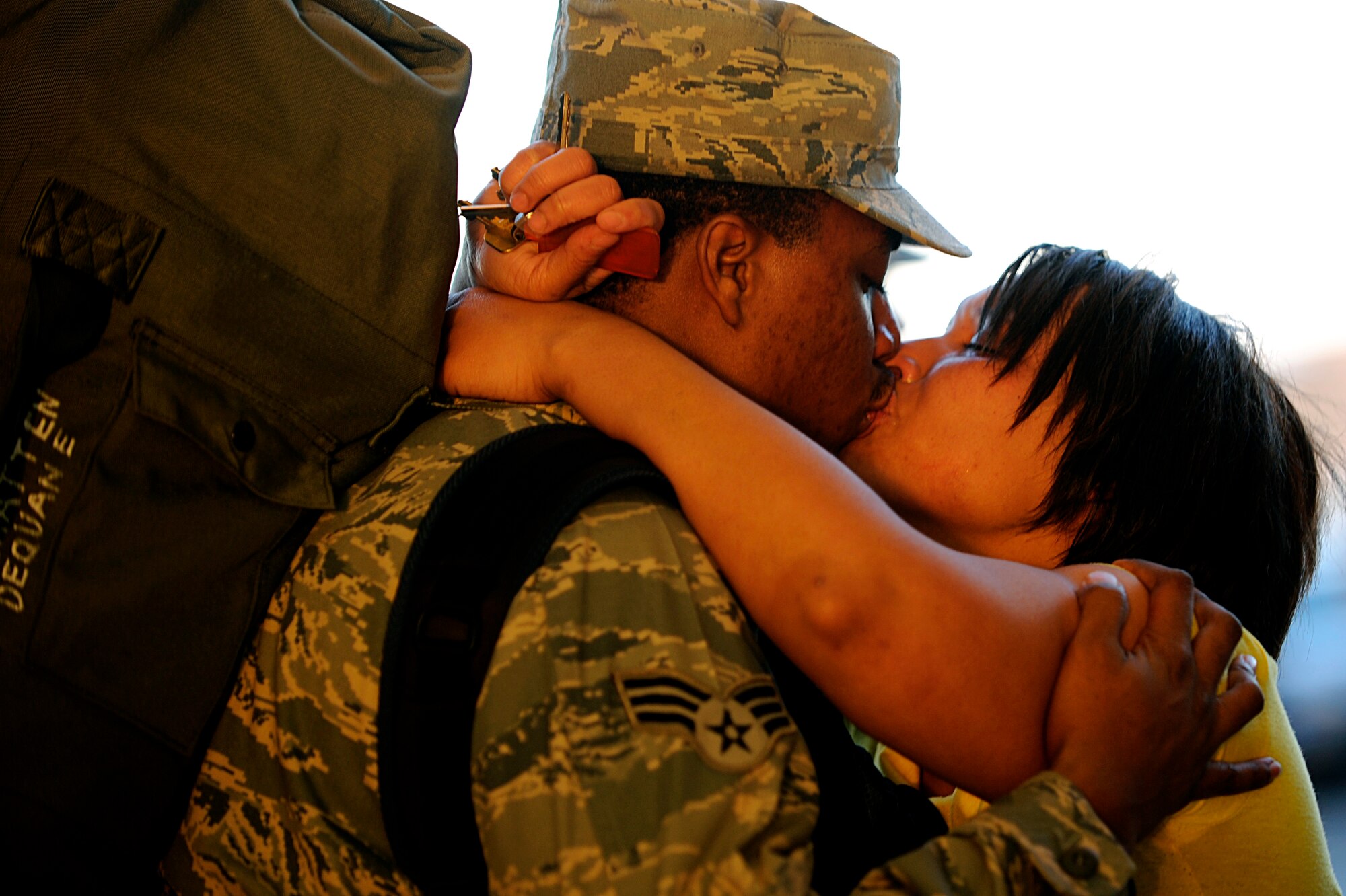 ELLSWORTH AIR FORCE BASE, S.D. -- (Left) Senior Airman Dequan McHatten, 28th Aircraft Maintenance Squadron crew chief, kisses his fiancé goodbye, Jan. 17. Airman McHatten is one of more than 300 Ellsworth Airmen deployed to Southwest Asia to support operations for the 379th Air Expeditionary Wing. (U.S. Air Force photo/Airman 1st Class Matthew Flynn)