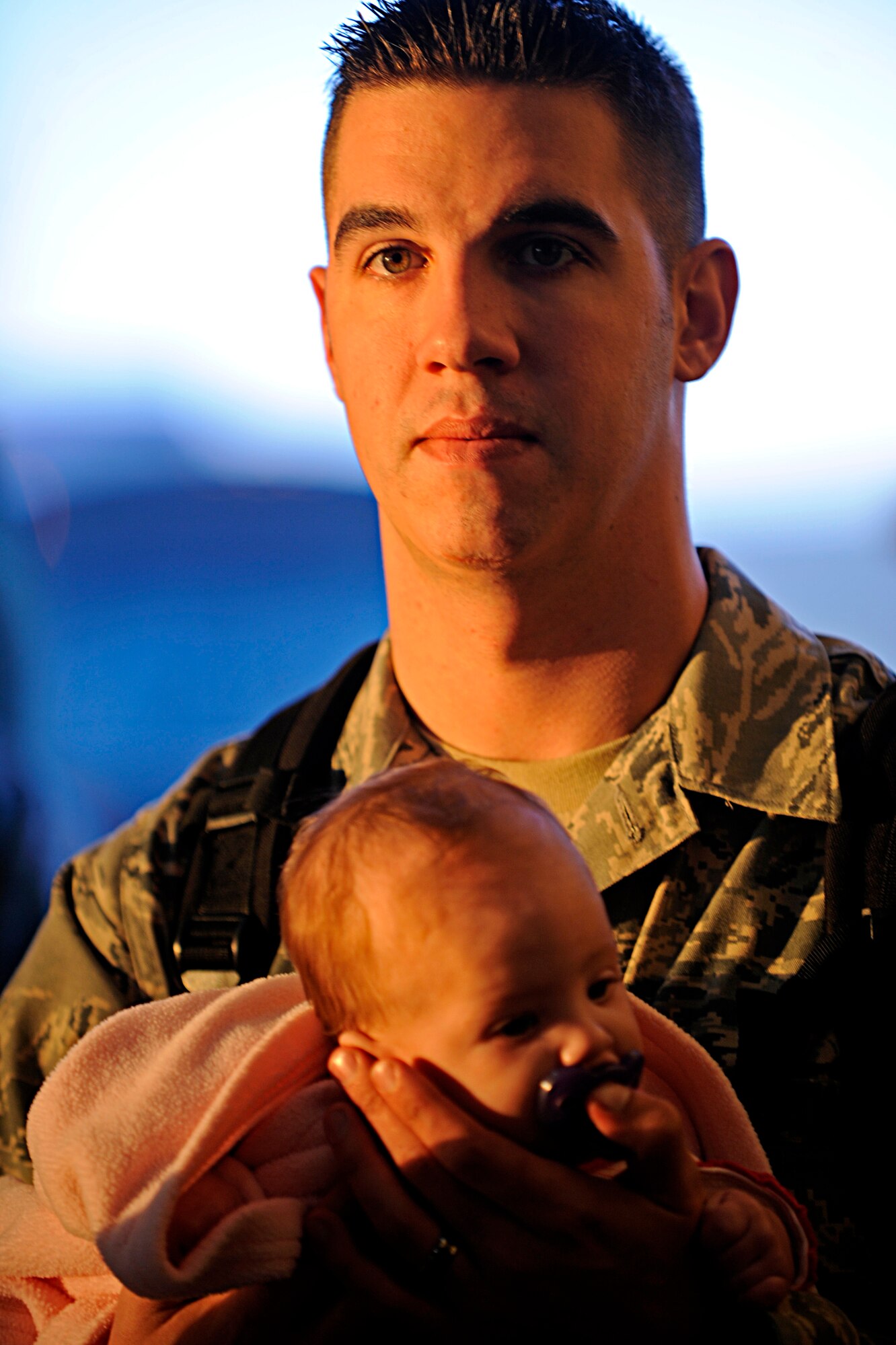 ELLSWORTH AIR FORCE BASE, S.D. -- Staff Sgt. Jesse Hutchings, 28th Maintenance Squadron reclamation and repair craftsman, holds his daughter before he begins his deployment processing, Jan. 17. Sergeant Hutchings is one of more than 300 Ellsworth Airmen deployed to Southwest Asia in support of today’s fight. (U.S. Air Force photo/Airman 1st Class Matthew Flynn)