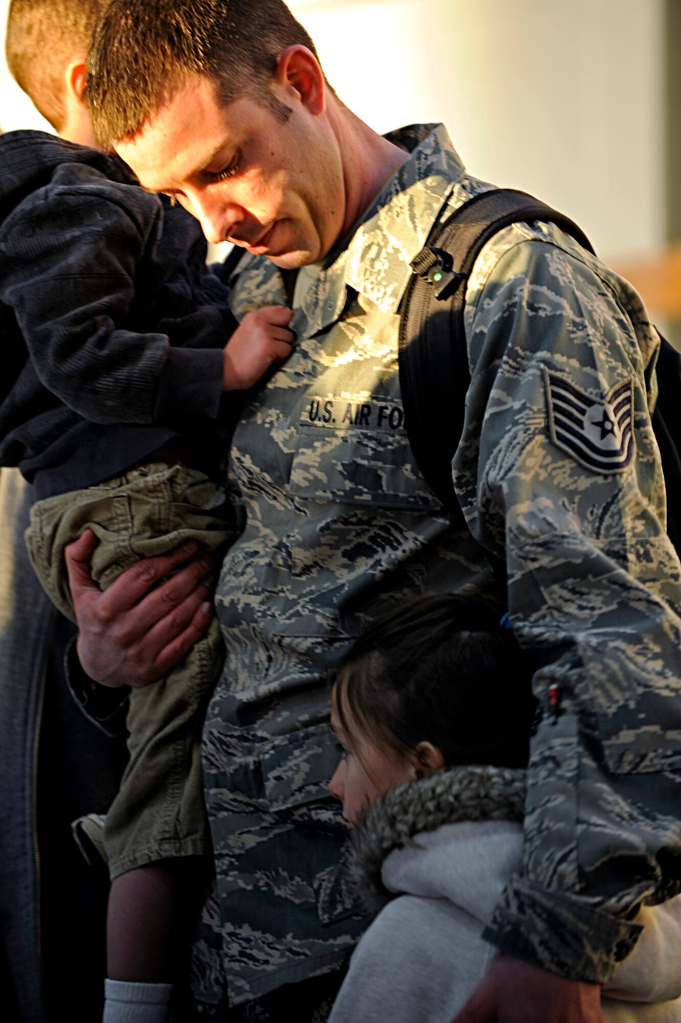 ELLSWORTH AIR FORCE BASE, S.D. -- Tech. Sgt. Jason Haynes, 28th Maintenance Squadron electronic warfare systems craftsman, consoles his children before he deploys to Southwest Asia, Jan. 17. Sergeant Haynes is deploying for the fourth time since joining the Air Force. (U.S. Air Force photo/Airman 1st Class Matthew Flynn)