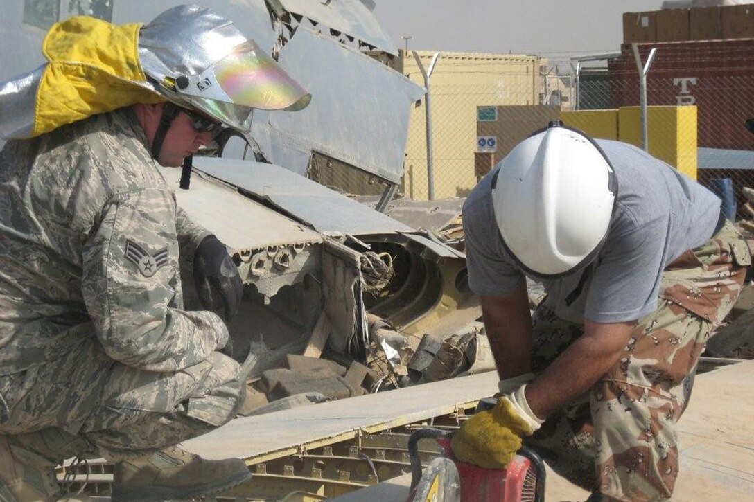 Senior Airman Jon Linn, firefighter with the 447th ECES/CEF instructs and Iraqi firefighter in the proper use of an extraction saw at a training facility located at Sather AB, Iraq. In addition to Senior Airman Linn?s normal duties of firefighting, building and equipment inspections, trains Iraqi firefighters from the surrounding fire departments enabling them to handle their firefighting role when the United States Air Force is no longer present in the area. Senior Airman Linn is filling an Expeditionary Combat Support rotation and is from the 132nd Fighter Wing, Des Moines, Iowa. (U.S. Air Force photo)