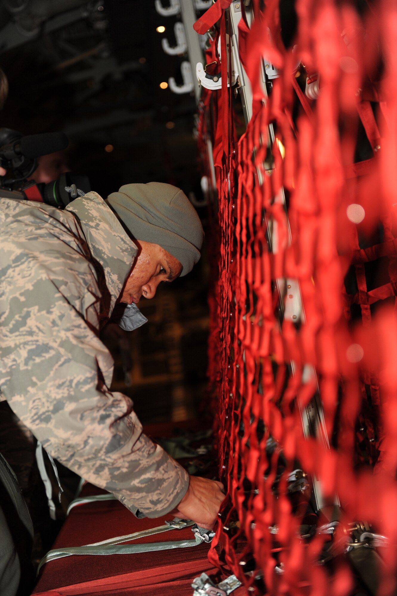 U.S. Air Force Tech. Sgt. Donny Poland ,a 19th Aircraft Maintenance Squadron
crew chief, finishes tightening troop seats on a C-130J Hercules in
preparation for transporting Soldiers Ft. Bragg, N.C.'s 82nd Airborne
Division Jan. 16, 2010 from Pope Air Force Base, N.C. to Haiti. Sergeant
Poland is based at Little Rock Air Force Base, Ark. Little Rock AFB is a
component of Air Mobility Command. Since Jan. 13, AMC has delivered more
than 1,600 tons of supplies as part of Operation Unified Response. AMC
aircraft and personnel continue to support the international effort to
increase the velocity with which aid is flowing to those in need earthquake
relief operation for the country of Haiti. (USAF Photo Staff Sgt. Chad
Chisholm) (RELEASED)
