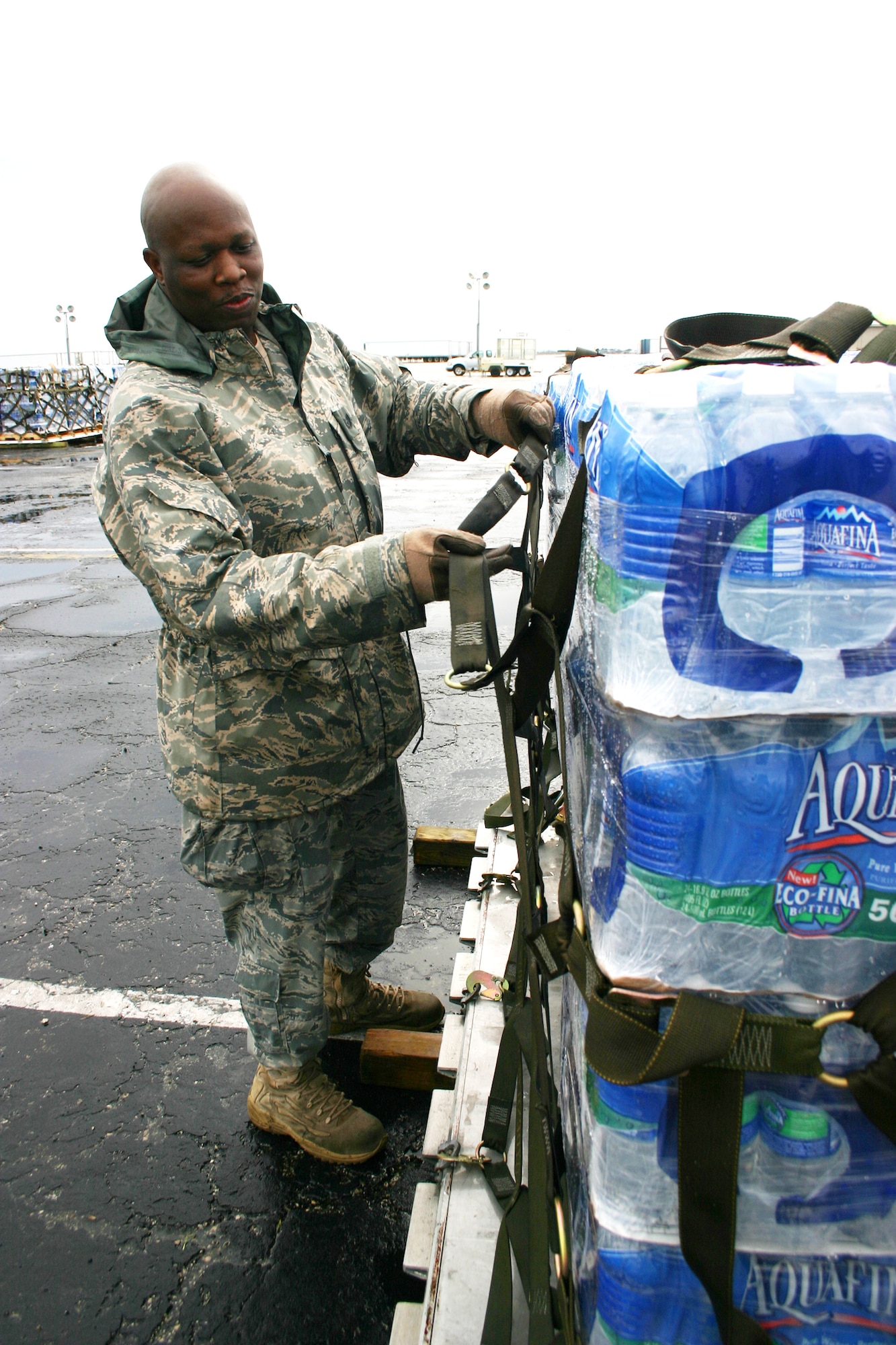 Tech. Sgt. Vincent Miller builds pallets of water to be delivered to Haiti Jan. 17, 2010, at Homestead Air Reserve Base, Fla. Sergeant Miller is an aerial port specialist assigned to the 70th Aerial Port Squadron at Homestead Air Reserve Base. (U.S. Air Force photo/ Master Sgt. Joseph Mather) 