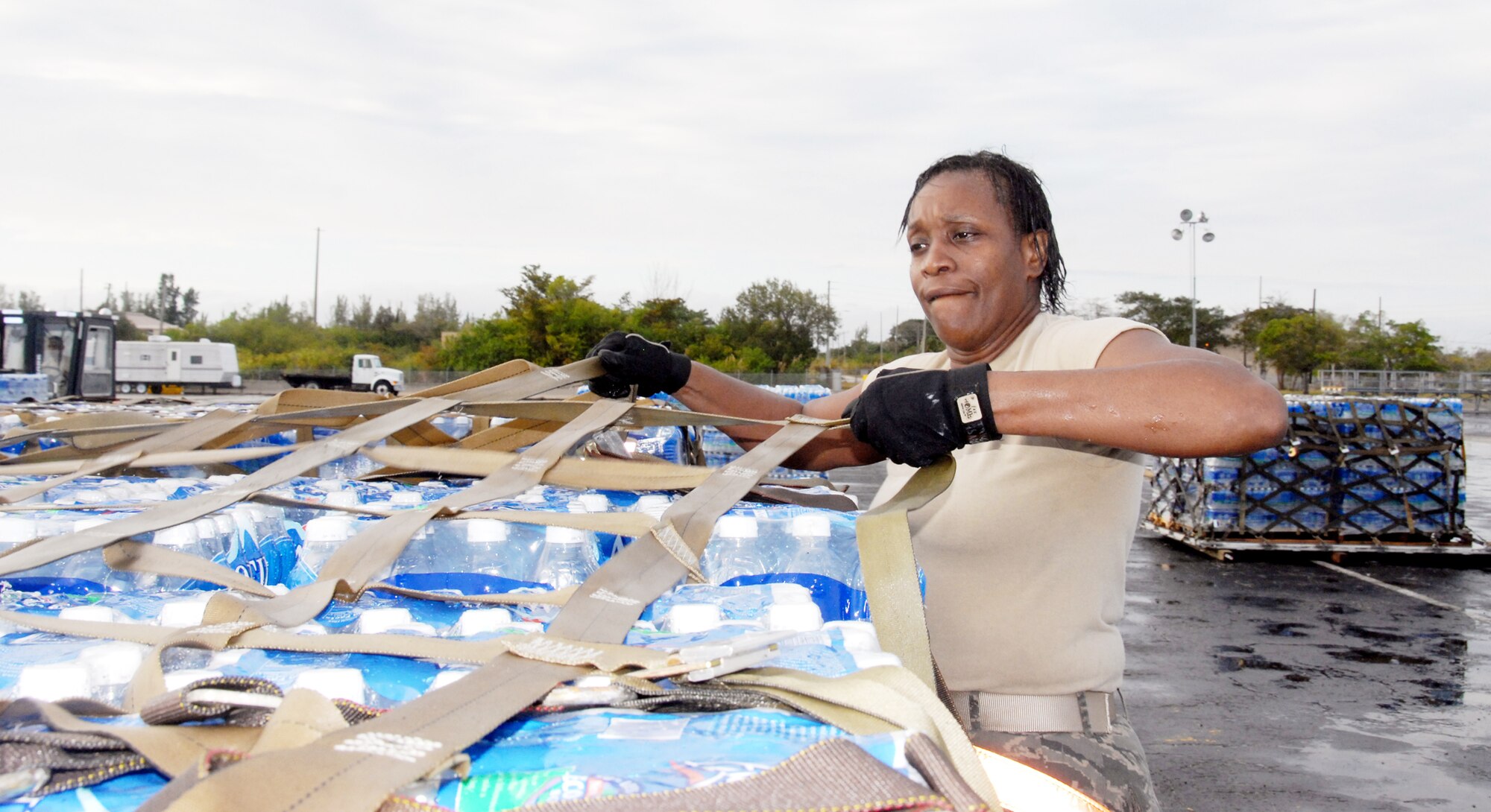 Tech. Sgt. Valerie McFadden builds pallets of water for Haiti relief efforts Jan. 17. 2010, at Homestead Air Reserve Base, Fla. Sergeant McFadden volunteered to provide essential support to the 70th Aerial Port Squadron for Haiti relief. Seargent McFadden is a aerial port specialist with the 46th Aerial Port Squadron at Dover Air Force Base, Del. (U.S. Air Force photo/ Master Sgt. Chance Babin)
