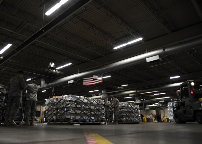 Members of the 437th Aerial Port Squadron build pallets of water to be shipped to Haiti on Charleston AFB, Jan. 19. Air Mobility Command is participating in a swift and coordinated relief effort to save lives in the aftermath of the earthquake that struck Port-au-Prince, Haiti. (U.S. Air Force photo/Senior Airman Katie Gieratz)(RELEASED)

