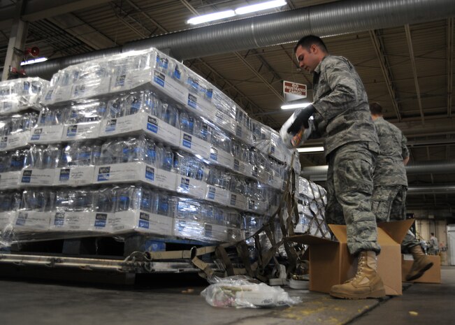 Airman Brett Swain helps build a pallet of water on Charleston AFB, Jan. 19. The water is being sent to Haiti to assist in the humanitarian relief effort. Airman Swain is an air transportation apprentice with the 437th Aerial Port Squadron. (U.S. Air Force photo/Senior Airman Katie Gieratz)(RELEASED) 