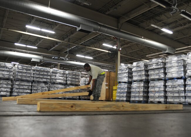 Staff Sgt. Denny Garrison prepares an area to build a pallet with water on Charleston AFB, Jan. 19. Air Mobility Command is participating in a swift and coordinated relief effort to save lives in the aftermath of the earthquake that struck Port-au-Prince, Haiti. Sergeant Garrison is a cargo services supervisor with the 437th Aerial Port Squadron.(U.S. Air Force photo/Senior Airman Katie Gieratz)(RELEASED)