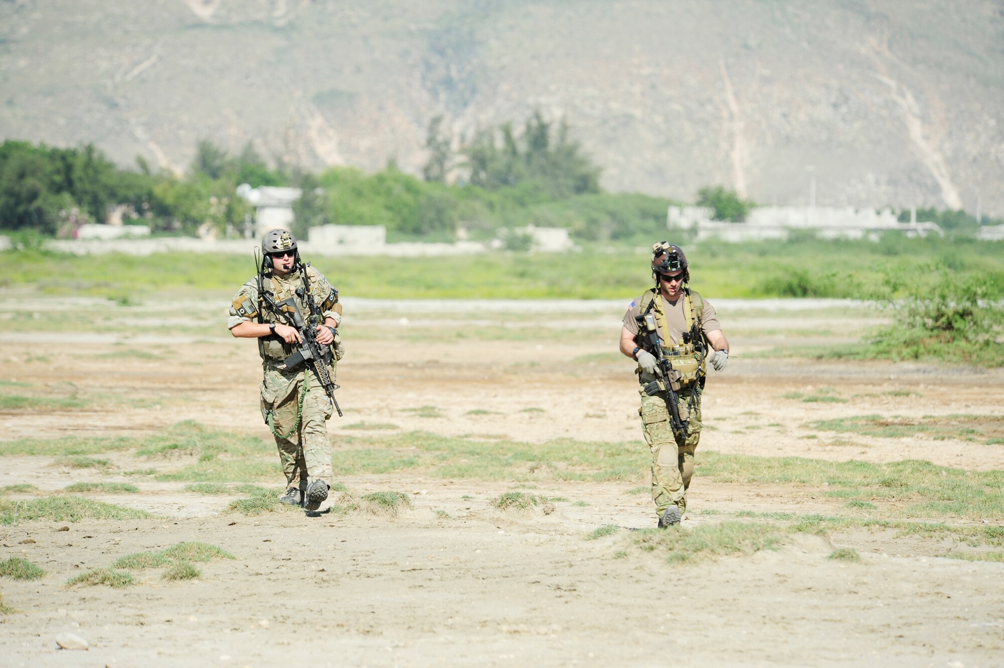 Air Force combat controllers survey a drop zone prior to an air delivery of humanitarian aid in Port-au-Prince, Haiti, Jan 18, 2010. Department of Defense assets have been deployed to assist in the Haiti relief effort following a magnitude 7 earthquake that hit the city on Jan. 12, 2010. The combat controllers are assigned to the 23rd Special Tactics Squadron at Hurlburt Field Fla. (U.S. Air Force photo/Tech. Sgt. James L. Harper Jr.)
