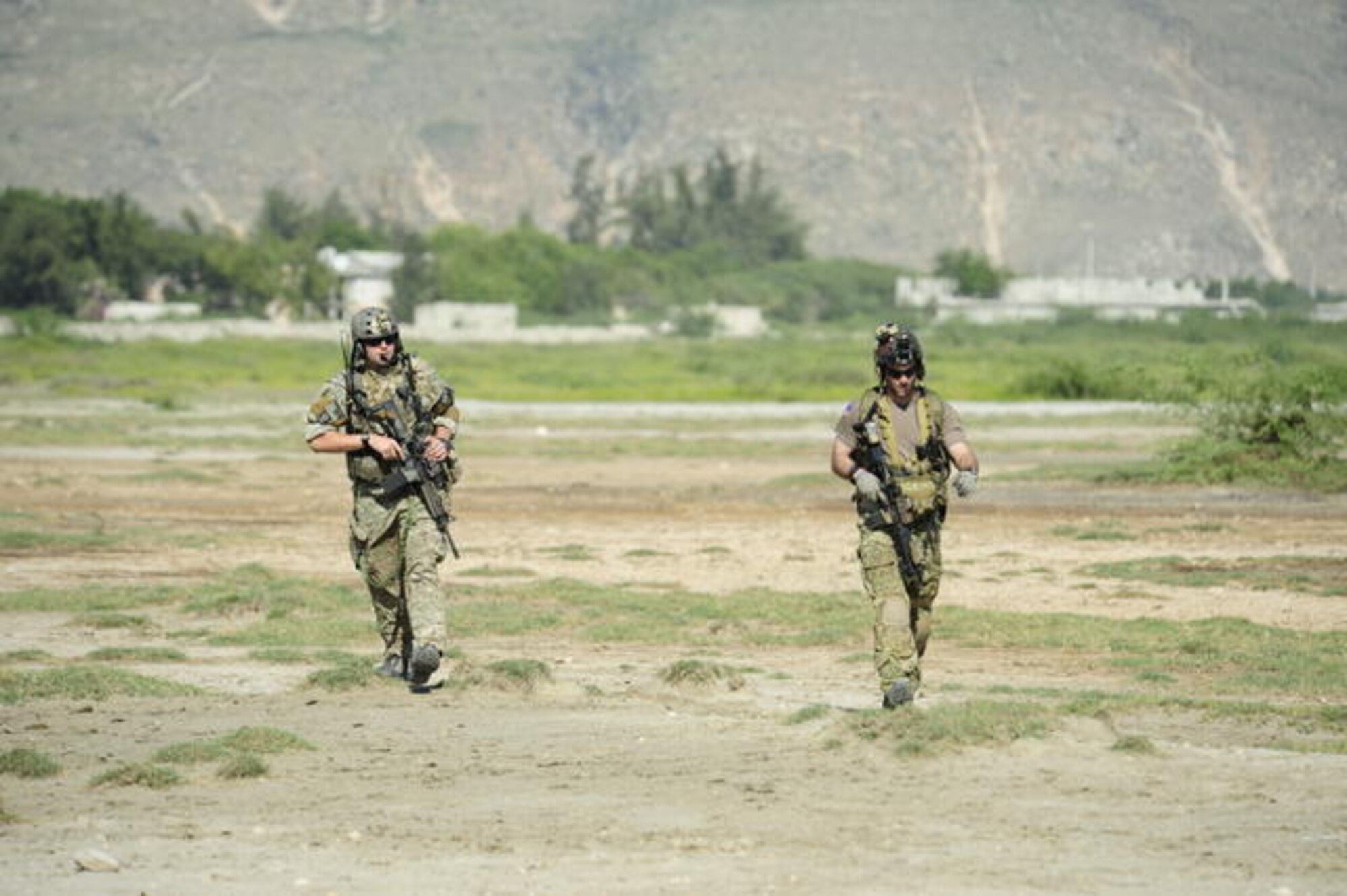 U.S. Air Force combat controllers from the 23rd Special Tactics Squadron, Air Force Special Operations Command, Hurlburt Field, Fla., survey a drop zone before humanitarian aid is airdropped Jan. 18, 2010, in Port-au-Prince, Haiti. U.S. Department of Defense assets have been deployed to assist in the Haiti relief effort following a magnitude 7 earthquake that hit the city Jan. 12, 2010. (U.S. Air Force photo by Tech. Sgt. James L. Harper Jr./Released)