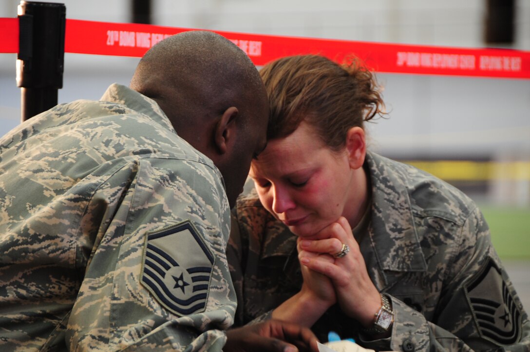 ELLSWORTH AIR FORCE BASE, S.D. -- (Left to right) Master Sgt. Charles Stansbury, 28th Aircraft Maintenance Squadron specialist section chief, consoles his wife Master Sgt. Jeanna Stansbury, 28th Force Support Squadron sustainment flight superintendent, before deploying to Southwest Asia, Jan. 17.  This is the first time the Stansburys will be separated longer than a few weeks since they've been married. (U.S. Air Force photo/Airman 1st Class Anthony Sanchelli)