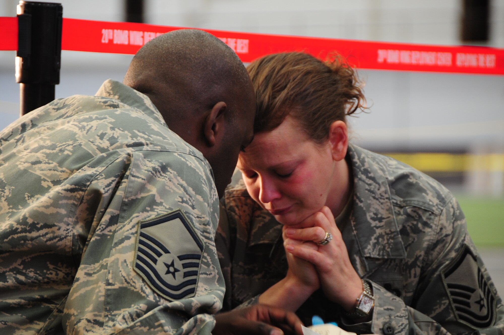 ELLSWORTH AIR FORCE BASE, S.D. -- (Left to right) Master Sgt. Charles Stansbury, 28th Aircraft Maintenance Squadron specialist section chief, consoles his wife Master Sgt. Jeanna Stansbury, 28th Force Support Squadron sustainment flight superintendent, before deploying to Southwest Asia, Jan. 17.  This is the first time the Stansburys will be separated longer than a few weeks since they've been married. (U.S. Air Force photo/Airman 1st Class Anthony Sanchelli)