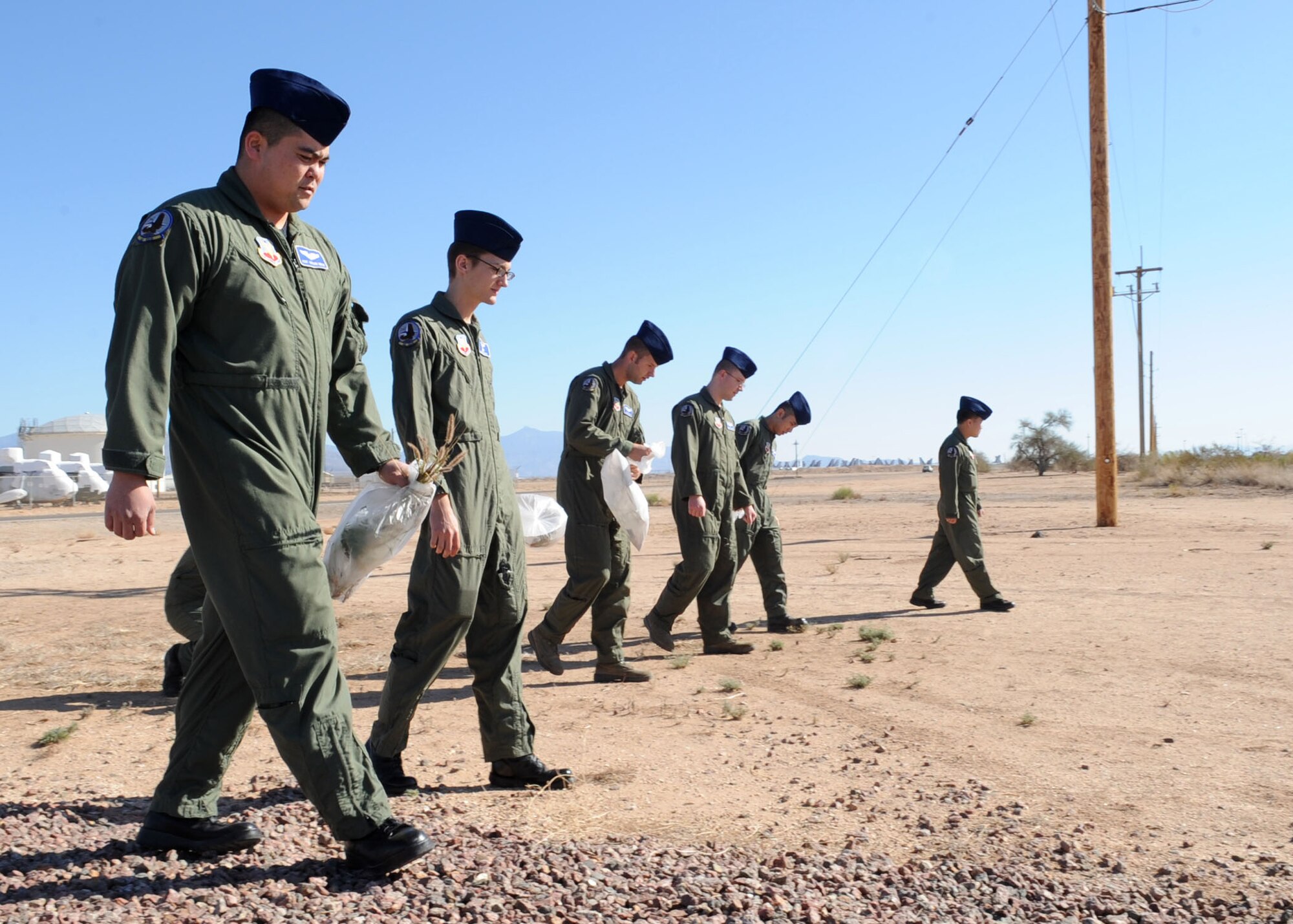 Staff Sgt. Tatsuki Kinjo, alongside other members of the 42nd Electronic Combat Squadron take time out of their day to pick up trash as part of the Tucson 12-Minute Makeover event here Jan. 12. Residents of Tucson were encouraged to step outside and clean up around their homes, work or play areas as part of this community-wide litter clean up. This event aimed to encourage community pride. (U.S. Air Force photo/Airman Jerilyn Quintanilla)
