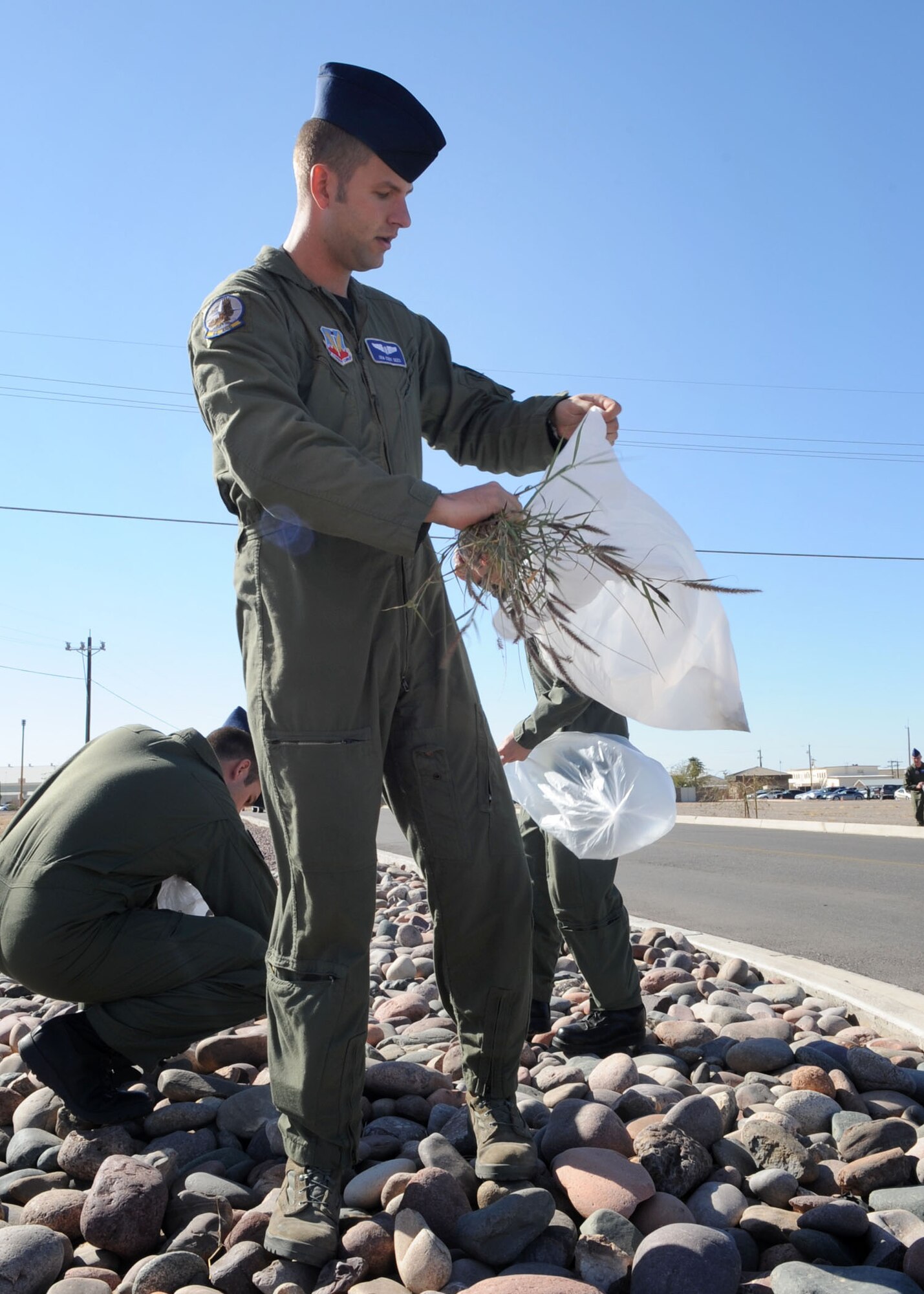 Senior Airman Cody Dees, along with 40 members of the 42nd Electronic Combat Squadron, take time out of their day to pick up trash as part of the Tucson 12-Minute Makeover event here Jan. 12. Residents of Tucson were encouraged to step outside and clean up around their homes, work or play areas. The goal for this community-wide litter clean up was to encourage community pride. (U.S. Air Force photo/Airman Jerilyn Quintanilla)
