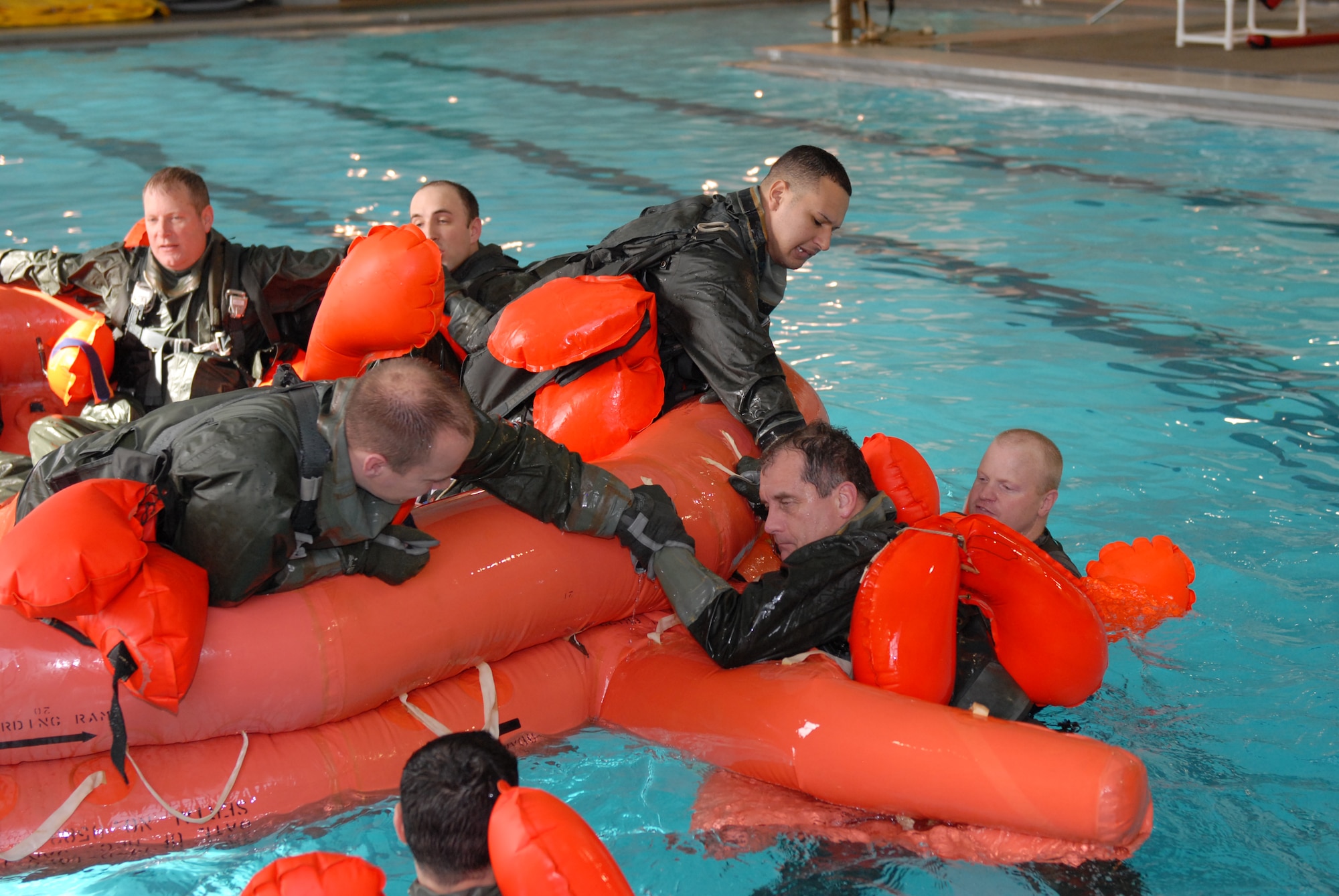 Little Rock Air Force Base aviators attend survival water training Jan. 15 at Jacksonville Community Center pool.  Tech. Sgt. Scott Lawrence, 19th Operations Support Squadron teaches survival water training to C-130 aviators to familiarize survival tactics in case of emergency exit over water. (U. S. Air Force photo by Senior Airman Christine Clark)