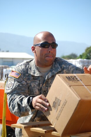 Army Sgt. 1st Class Michael Billman packs Meals Ready to Eat boxes onto vehicles for Soldiers providing relief efforts in Port-au-Prince, Haiti, Jan. 18, 2010. Sergeant Billman is assigned to the 82nd Airborne Division, Fort Bragg, N.C. (U.S. Air Force photo/Master Sgt. Sean P. Houlihan)