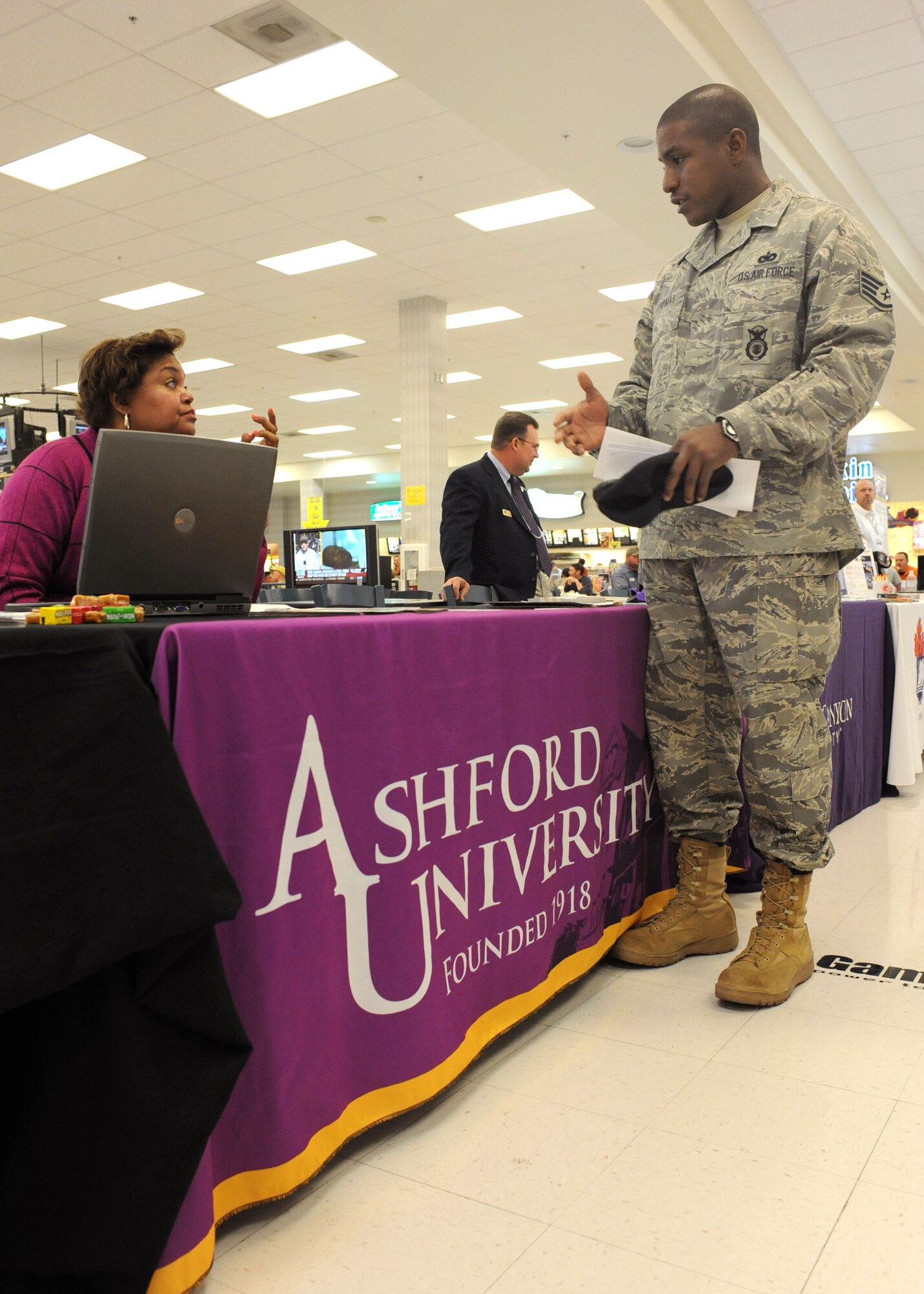 Staff Sgt. Jarmaine Thomas, 355th Security Forces Squadron, speaks to a representative from Ashford University at the College Day event here, Jan. 15. This quarterly event is hosted by the Davis- Monthan Education center, and is open to all military members as well as dependents and retirees. Representatives from approximately 30 different colleges were on base to take part in the event and provide information about their institution and the different certification programs they offer. (U.S. Air Force photo/Airman Jerilyn Quintanilla)