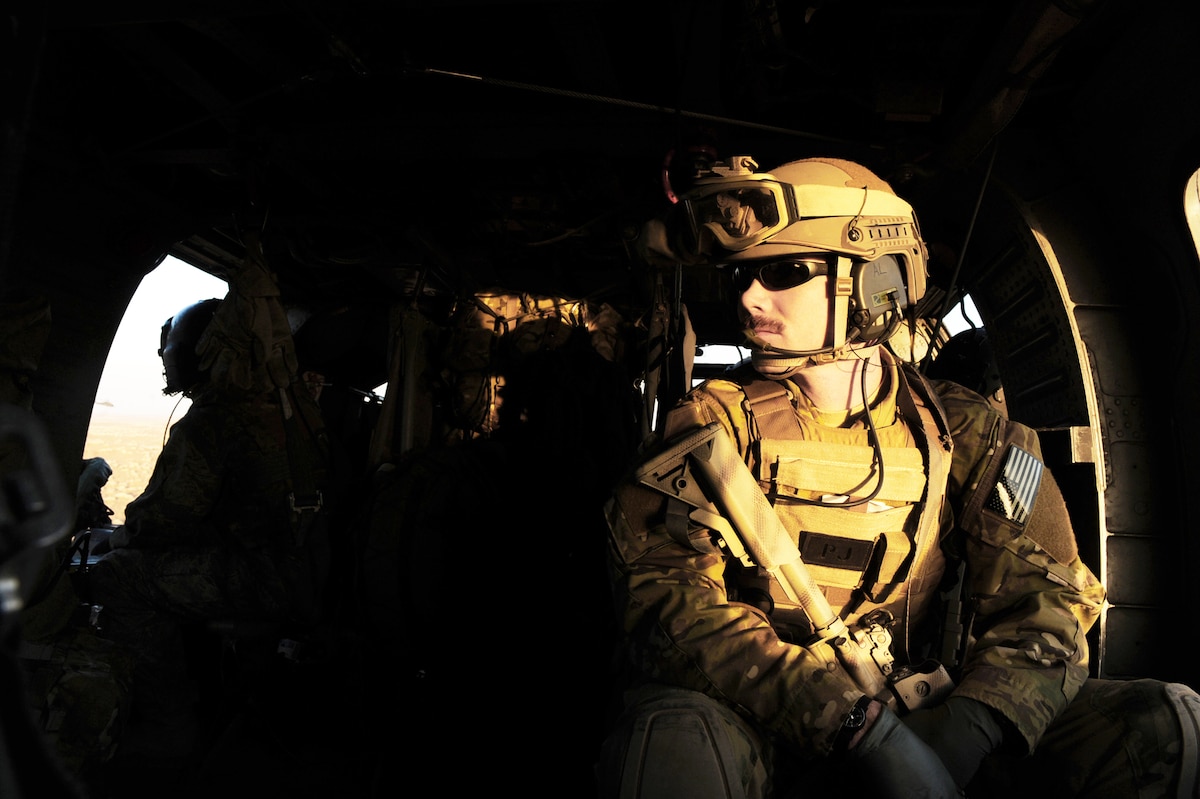 Staff Sgt. Demian Abel scans the horizon for potential threats to his HH-60G Pave Hawk crew during a medical evacuation mission, Jan. 10, 2010, over Kandahar Province, Afghanistan. Sergeant Abel is a pararescueman with the 66th Expeditionary Rescue Squadron. (U.S. Air Force photo/Staff Sgt. Manuel J. Martinez)