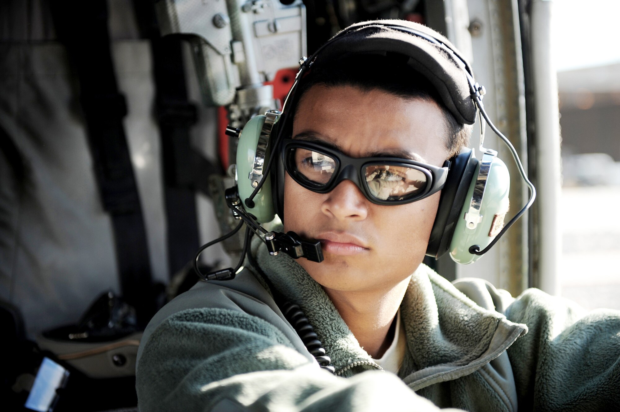 Senior Airman Harvey Gonzales waits onboard a HH-60G Pave Hawk prior to a medical evacuation mission, Jan. 10, 2010, at Kandahar Airfield, Afghanistan. Airman Gonzales is a crew chief with the 66th Expeditionary Rescue Squadron, (U.S. Air Force photo/Staff Sgt. Manuel J. Martinez)