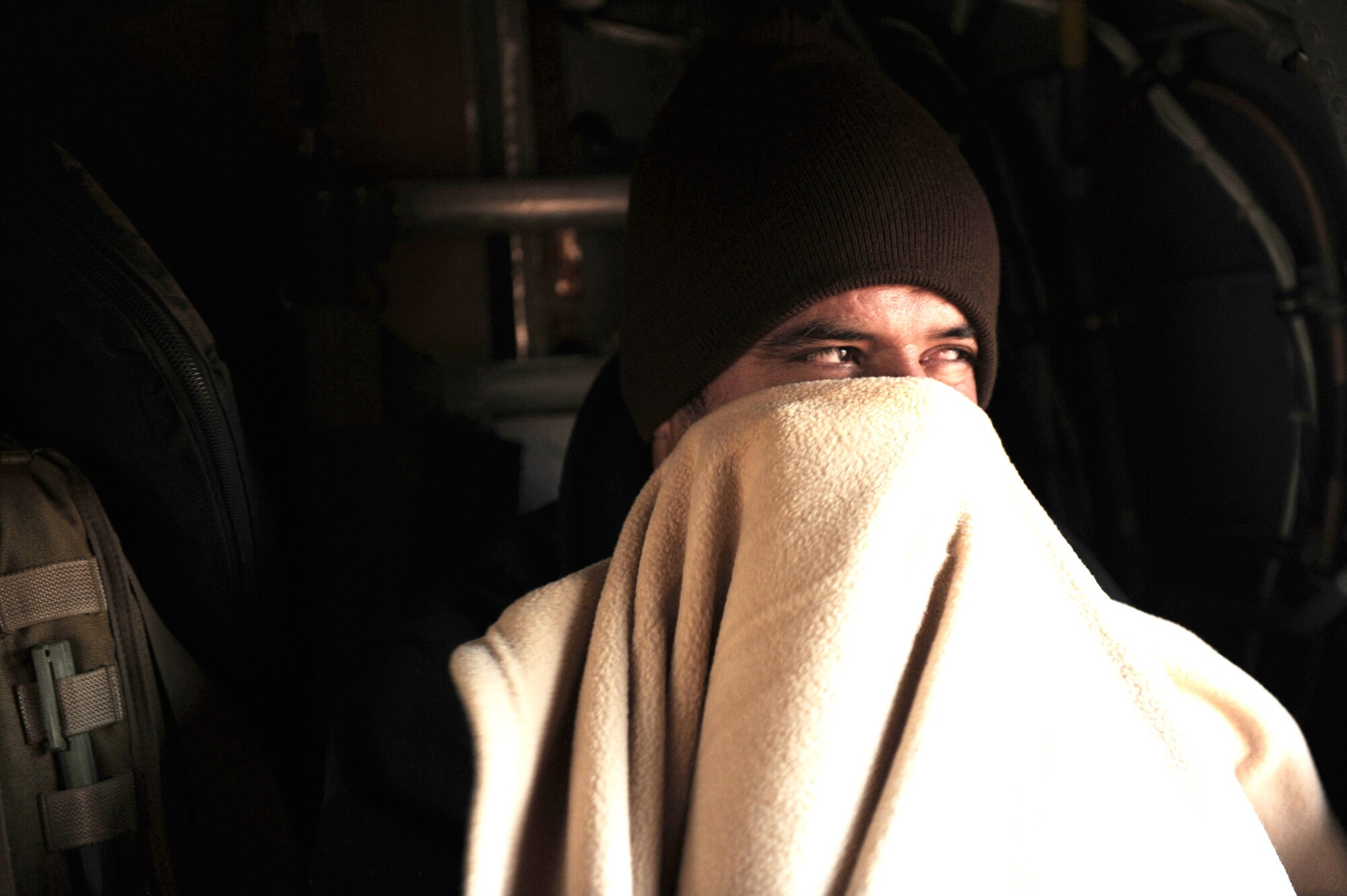 An Afghan National Army soldier warms himself during a medical evacuation aboard a HH-60G Pave Hawk, Jan. 10, 2010, at Kandahar Airfield, Afghanistan. (U.S. Air Force photo/Staff Sgt. Manuel J. Martinez)