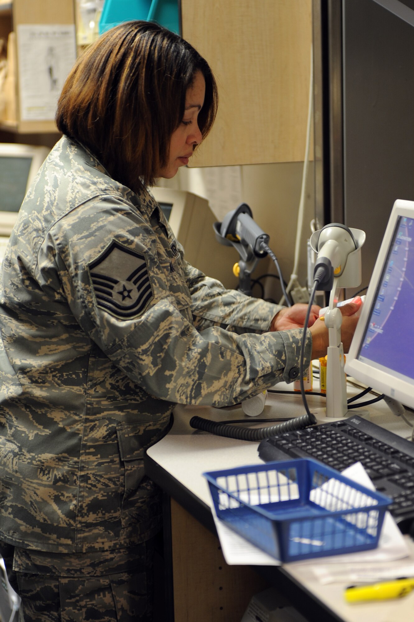 WHITEMAN AIR FORCE BASE, Mo. - Master Sgt. Knicole Akins, 509th Medical Group NCO in charge of pharmacy services, reviews a customer's prescription one last time before it goes out the help window, Jan. 15, 2010. Sergeant Atkins also reviews dosage and special instructions with the customer and answers any questions they may have about their prescription. (U.S. Air Force photo by Airman 1st Class Carlin Leslie) (Released)
