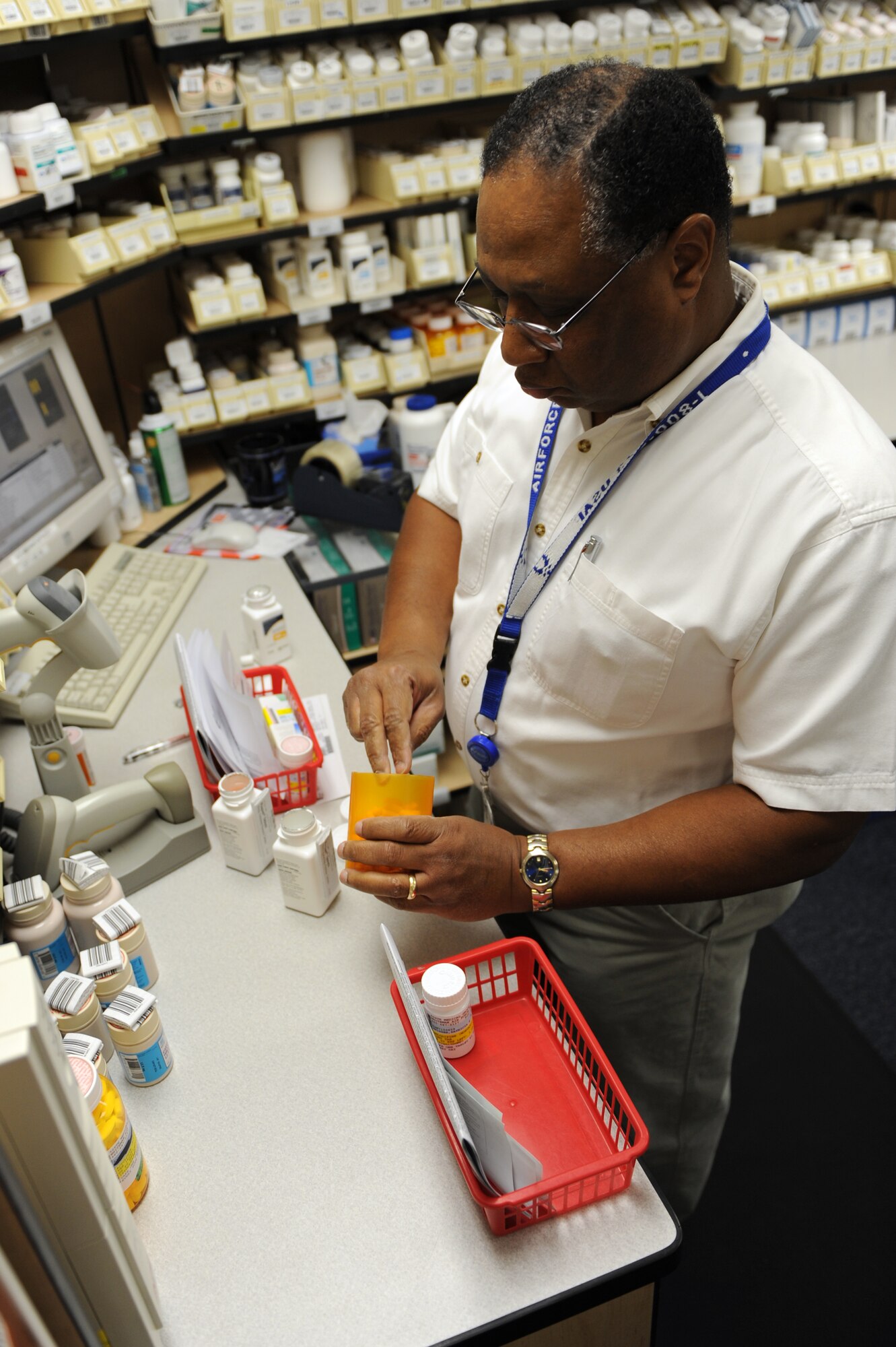 WHITEMAN AIR FORCE BASE, Mo. - Ernie Carpenter, 509th Medical Group civilian pharmacy technician, reviews filled prescriptions to ensure the correct amount of medicine is given and double checks the information on the bottle, Jan. 15, 2010. (U.S. Air Force photo by Airman 1st Class Carlin Leslie) (Released)
