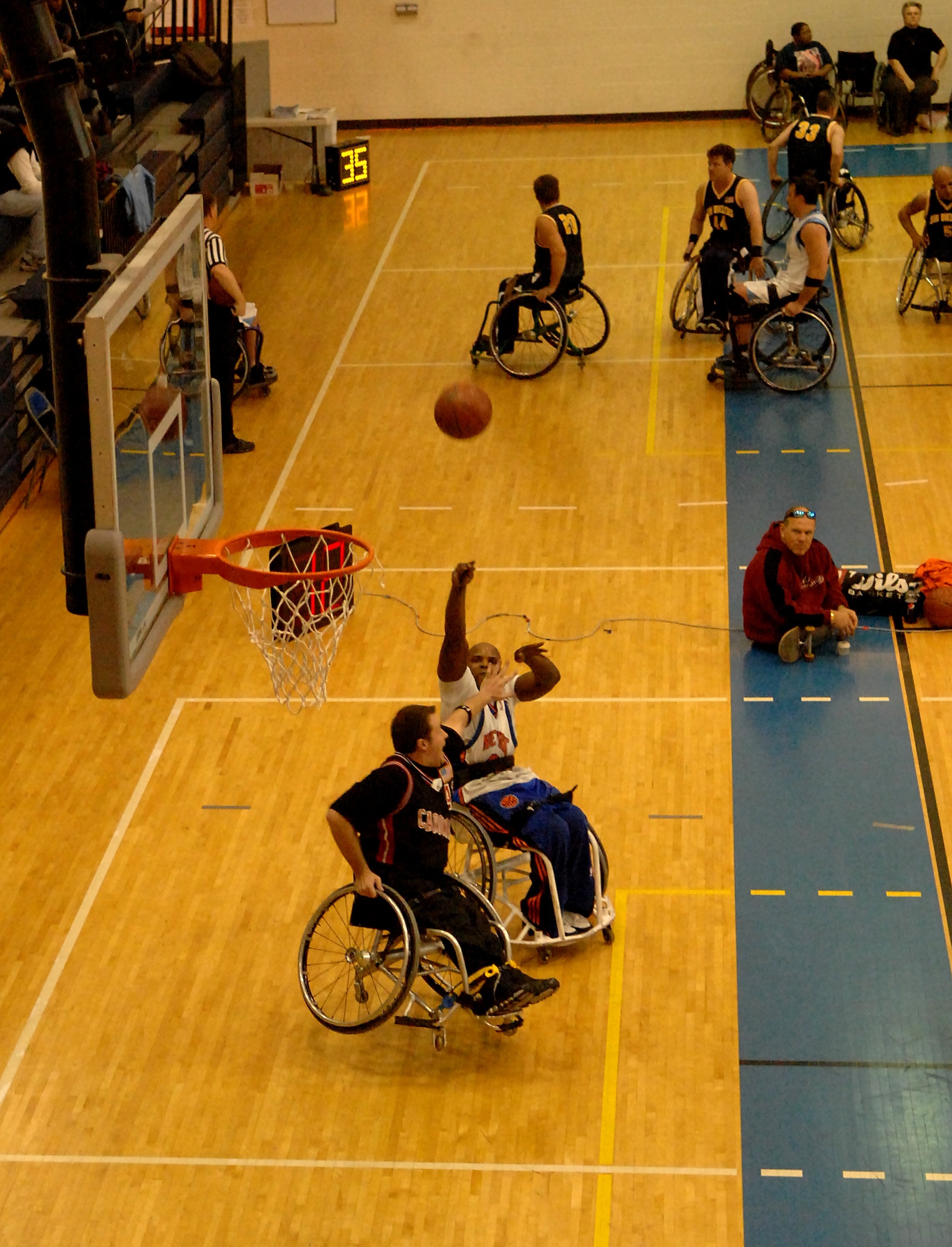 LANGLEY AIR FORCE BASE, Va. -- New York Rollin' Knicks forward Kevin Grant shoots over Charlottesville Cardinals guard Russell Scott in a tournament game Jan. 17. The Rollin' Knicks won the  game in overtime 68-65. (U.S. Air Force photo/Airman 1st Class Jason J. Brown)