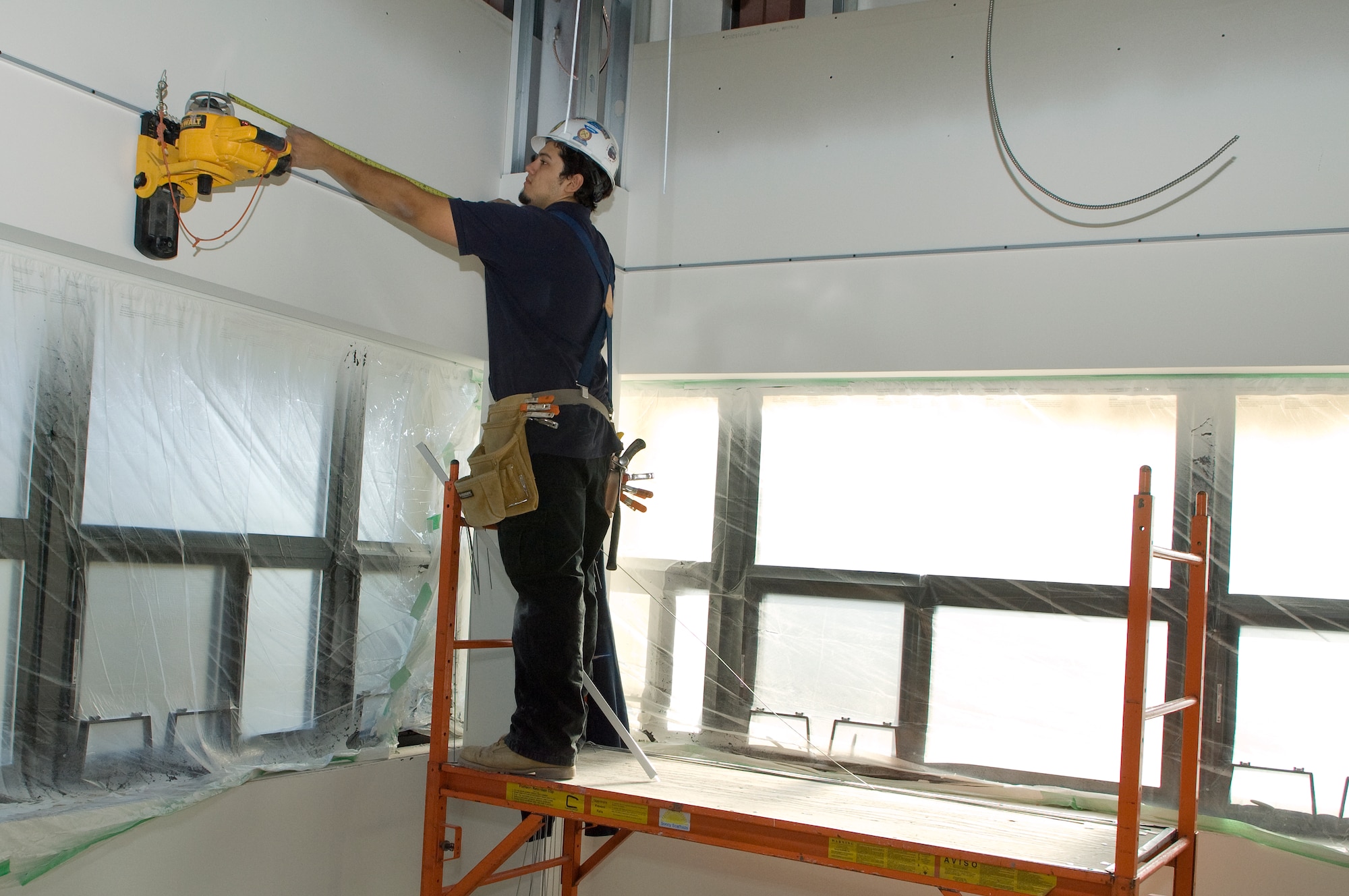 Antonio Marin of Advanced Acoustical Systems installs a drop ceiling on the second floor of Bldg 1604 last month.  The new facility, scheduled to open later in the spring, will offer increased space with comparatively reduced costs. (U.S. Air Force Photo by Mark Wyatt)