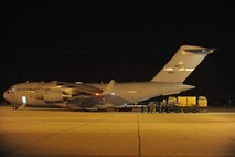 Airmen from the 452nd Aerial Support Flight load USAID equipment into a C-17 Globemaster III from the 60th Air Wing, Travis Air Force Base, Calif., parked at March Air Reserve Base, Calif., Jan. 13., 2010. The aircraft transported a 72-member urban search and rescue team and their supplies to help with the relief effort in Haiti following the devistating Jan. 12 earthquake.  (U.S. Air Force Photo/Master Sgt. Roy Santana)