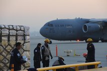 Members of the USAID urban search and rescue team from the Los Angeles County Fire Department arrange their rescue equipment at March Air Reserve Base, Calif., in preparation for their Jan. 13 flight to Port-Au-Prince, Haiti, to assist with the earthquake relief effort.  The C-17 Globemaster III that transported the 72-person team and their equipment is from the 60th Air Wing, Travis Air Force Base, Calif.  The aircraft arrived in Haiti Jan. 14. (U.S. Air Force Photo/Master Sgt. Roy Santana)