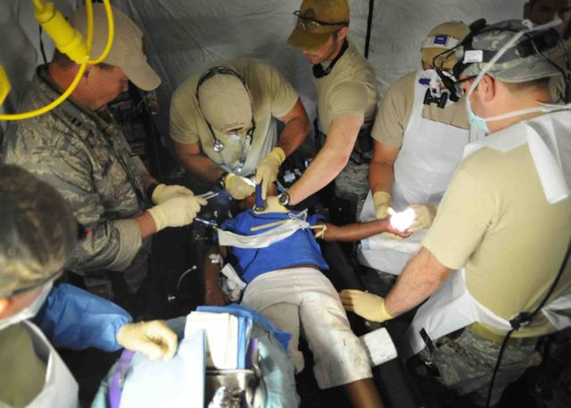 U.S. Airmen with the 1st Special Operations Support Squadron offer medical assistance to a Haitian girl at the Toussaint Louverture International Airport in Port-au-Prince, Haiti, Jan. 16, 2010. (U.S. Navy photo by Mass Communication Specialist 2nd Class Justin Stumberg/Released)