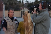 A Fox News camera team interviews a USAID member at March Air Reserve Base, Calif., Jan. 13.  The USAID urban search and rescue team from the Los Angeles County Fire Department was on base for a flight to Port-Au-Prince, Haiti, to assist with the earthquake relief effort.  The C-17 Globemaster III that transported the 72-person team and their equipment is from the 60th Air Wing, Travis Air Force Base, Calif.  The aircraft arrived in Haiti Jan. 14. (U.S. Air Force Photo/Master Sgt. Roy Santana)