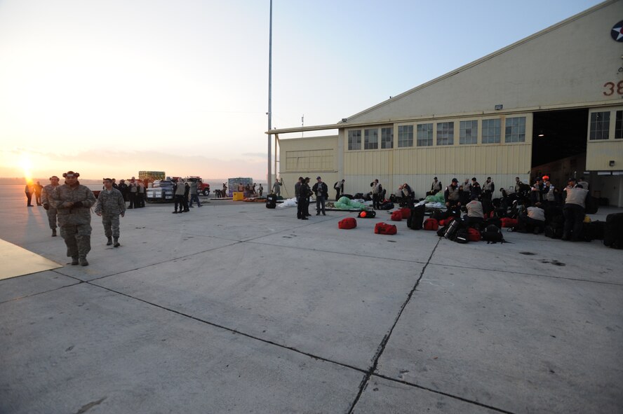 Members of the USAID urban search and rescue team from the Los Angeles County Fire Department arrange their rescue equipment at March Air Reserve Base, Calif., in preparation for their Jan. 13 flight to Port-Au-Prince, Haiti, to assist with the earthquake relief effort.  The C-17 Globemaster III that transported the 72-person team and their equipment is from the 60th Air Wing, Travis Air Force Base, Calif.  The aircraft arrived in Haiti Jan. 14. (U.S. Air Force Photo/Master Sgt. Roy Santana)