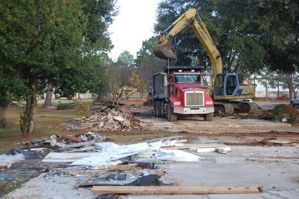Workers use construction equipment to remove debris left behind from the destruction of old base housing at Gunter. The space will be used to create a new fitness center. (USAF Photo by Carl Bergquist)

