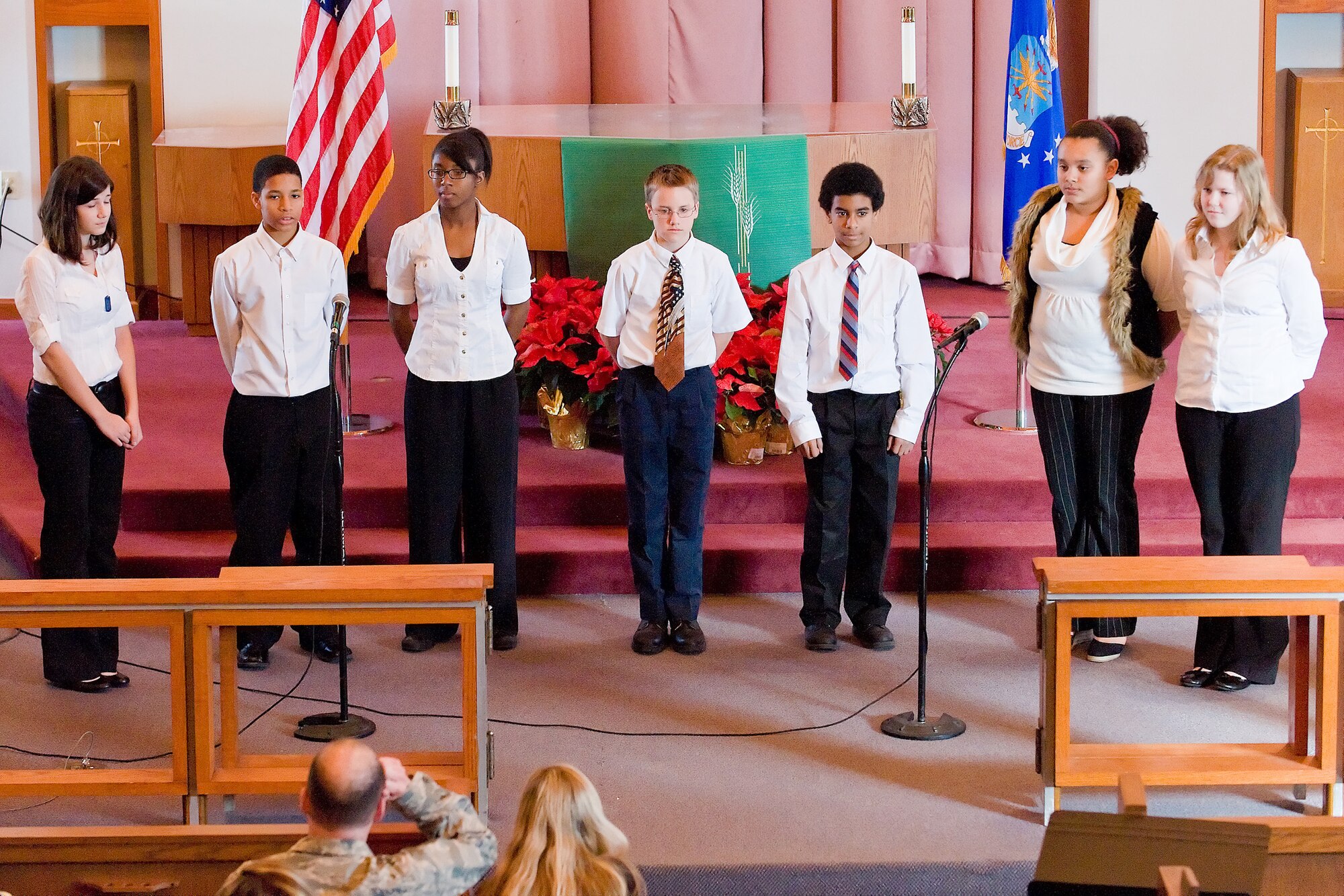 Students of the Dover Air Force Base Middle School perform a dramatic retelling of the ?I have a Dream? speech Jan. 13 at a commemorative service in the base chapel. The students performed the speech by each telling their own part of the whole work, ending in a unified finale. (U.S. Air Force photo/Roland Balik)
