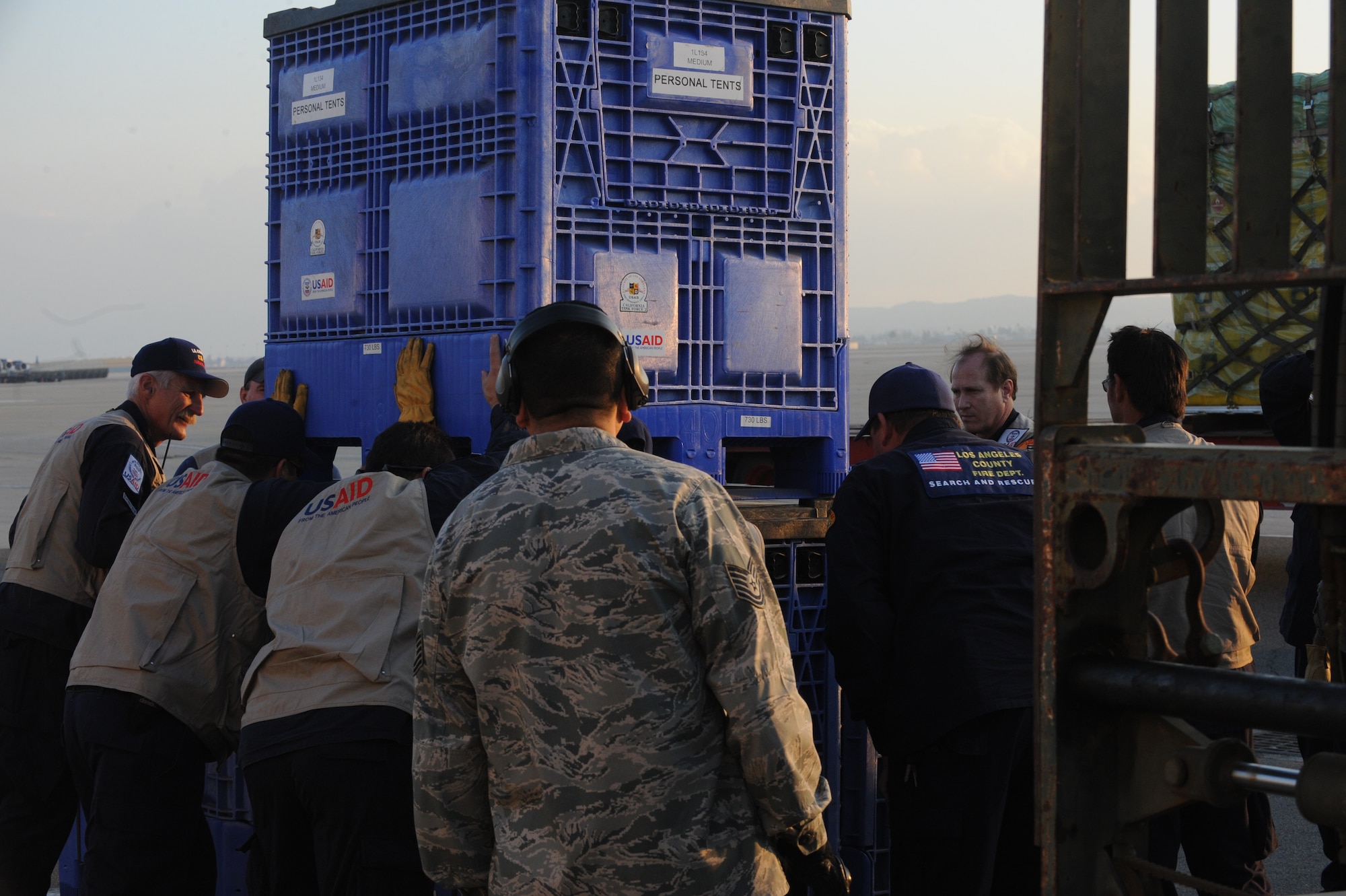 Members of the USAID urban search and rescue team from the Los Angeles County Fire Department arrange their rescue equipment at March Air Reserve Base, Calif., in preparation for their Jan. 13 flight to Port-Au-Prince, Haiti, to assist with the earthquake relief effort.  The C-17 Globemaster III that transported the 72-person team and their equipment is from the 60th Air Wing, Travis Air Force Base, Calif.  The aircraft arrived in Haiti Jan. 14. (U.S. Air Force Photo/Master Sgt. Roy Santana)