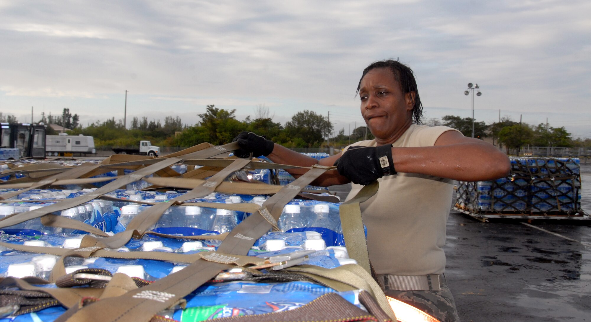 Tech. Sgt. Valerie McFadden, a reserve Aerial Port Specialist from the 46th Aerial Port Squadron at Dover Air Force Base, DE., is here at Homestead Air Reserve Base to provide essential support to the 70th Aerial Port Squadron for Haiti Relief.   Seargent McFadden is building Pallets of water that will be loaded on to aircraft and sent to Haiti.  (Air Force Photo/ Master Sgt. Chance Babin)