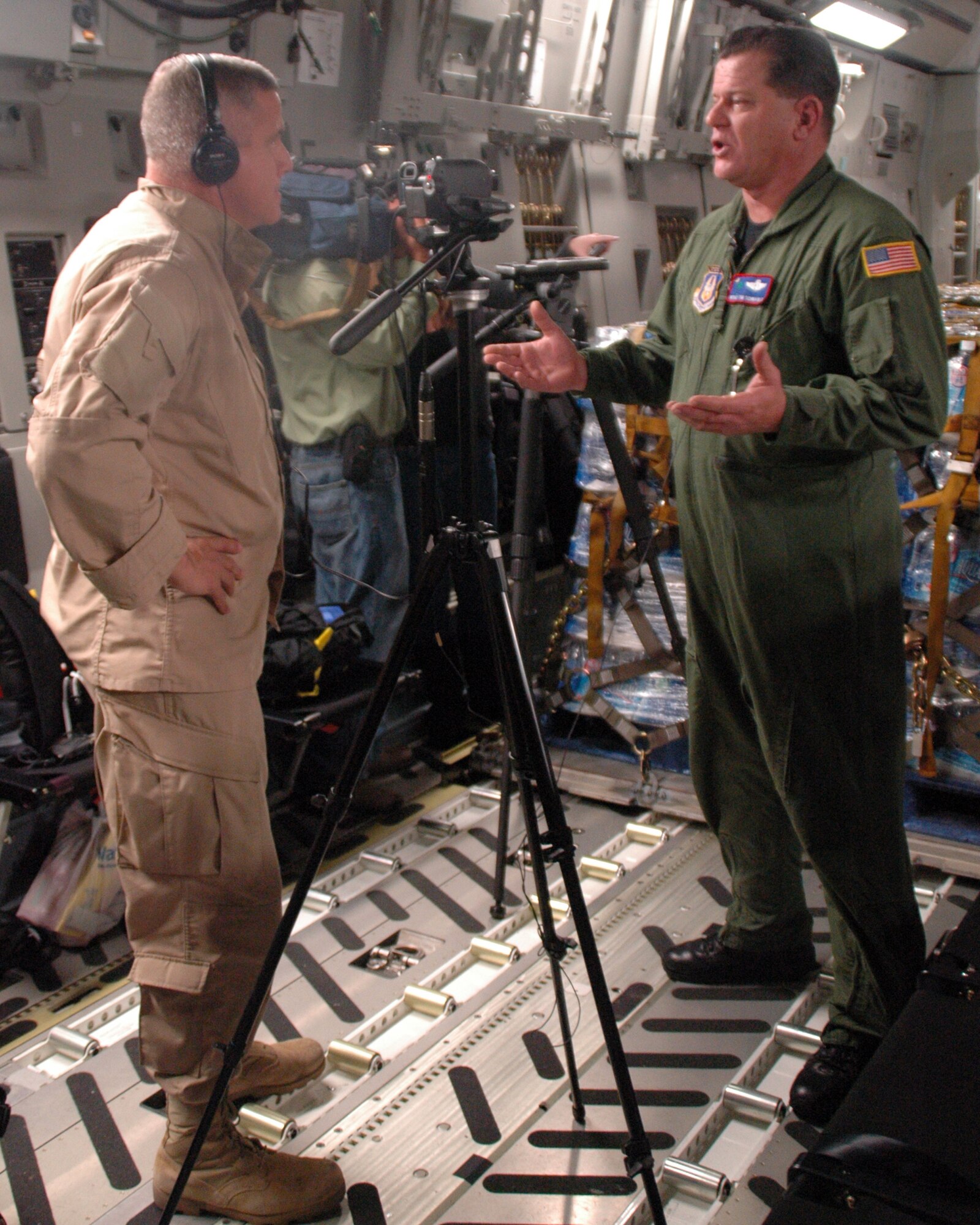 Master Sgt. Tim Schnaible, 701st AS loadmaster is interviewed by Randy Jackson, a communications specialist with Boeing Company. Boeing Company makes the C-17 and Jackson is covering the role that the airframe is playing in the Haitian relief effort. (U.S. Air Force photo/Tech. Sgt. Jeff Kelly)