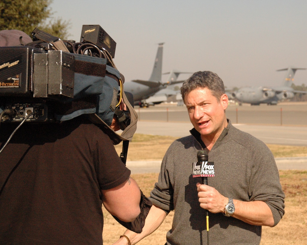FOX News reporter Rick Leventhal reports live from the flightline at Charleston Air Force Base, S.C. Leventhal explained the role that Team Charleston is playing in the Haitian relief effort to a national audience. (U.S. Air Force photo/Major Bill Walsh)