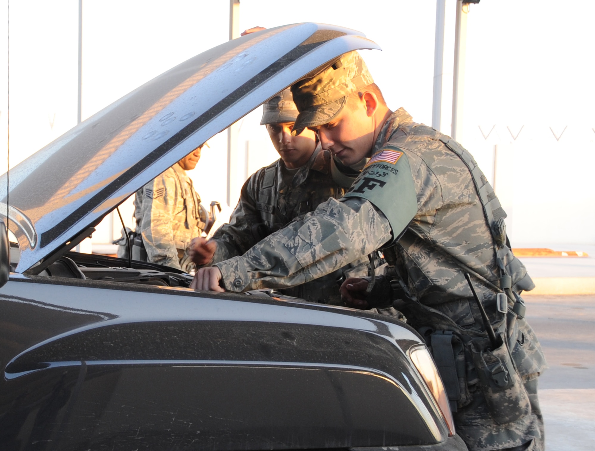 Security forces Airmen assigned to the 380th Expeditionary Security Forces Squadron search a vehicle in the vehicle search area of the 380th Air Expeditionary Wing compound at a non-disclosed base in Southwest Asia on Jan. 12, 2010. Security forces ensure the safety of 380th AEW personnel through efforts such as these at the vehicle search area.  The 380th AEW is comprised of four groups and 12 squadrons and the wing's deployed mission includes air refueling, surveillance, and reconnaissance in support of overseas contingency operations in Southwest Asia. The wing supports Operations Iraqi Freedom and Enduring Freedom and the Combined Joint Task Force-Horn of Africa. (U.S. Air Force Photo/Senior Airman Jenifer Calhoun/Released)