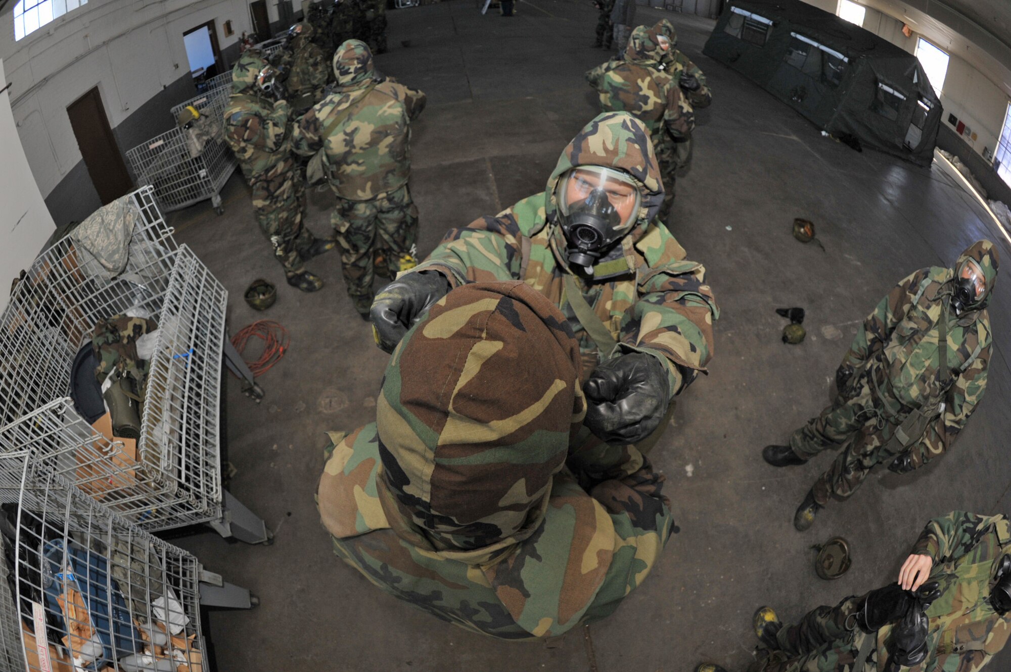 Tech. Sgt. Clay Dotson helps Capt. Mike McClain adjust a defensive suit while training at McConnell Air Force Base, Kan., on Jan. 10, 2010. Both Airmen are Reservists assigned to the 18th Air Refueling Squadron, the flying squadron of the 931st Air Refueling Group. Airmen assigned to the 18th ARS are preparing for an overseas deployment scheduled to begin in late February. (U.S. Air Force photo/Master Sgt. Jason Schaap)