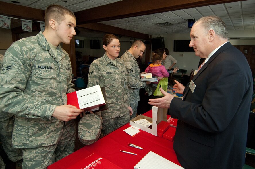 Airman 1st Class Patryk Podsiadlo and A1C Kari Snyder from the 66th Medical Group, discuss education options with J. Gerard Keegan, Boston University Metropolitan College assistant professor, at the Hanscom Education and Training Center's Education Fair, held Jan. 14 at the Minuteman Club.  (U.S. Air Force photo by Rick Berry)