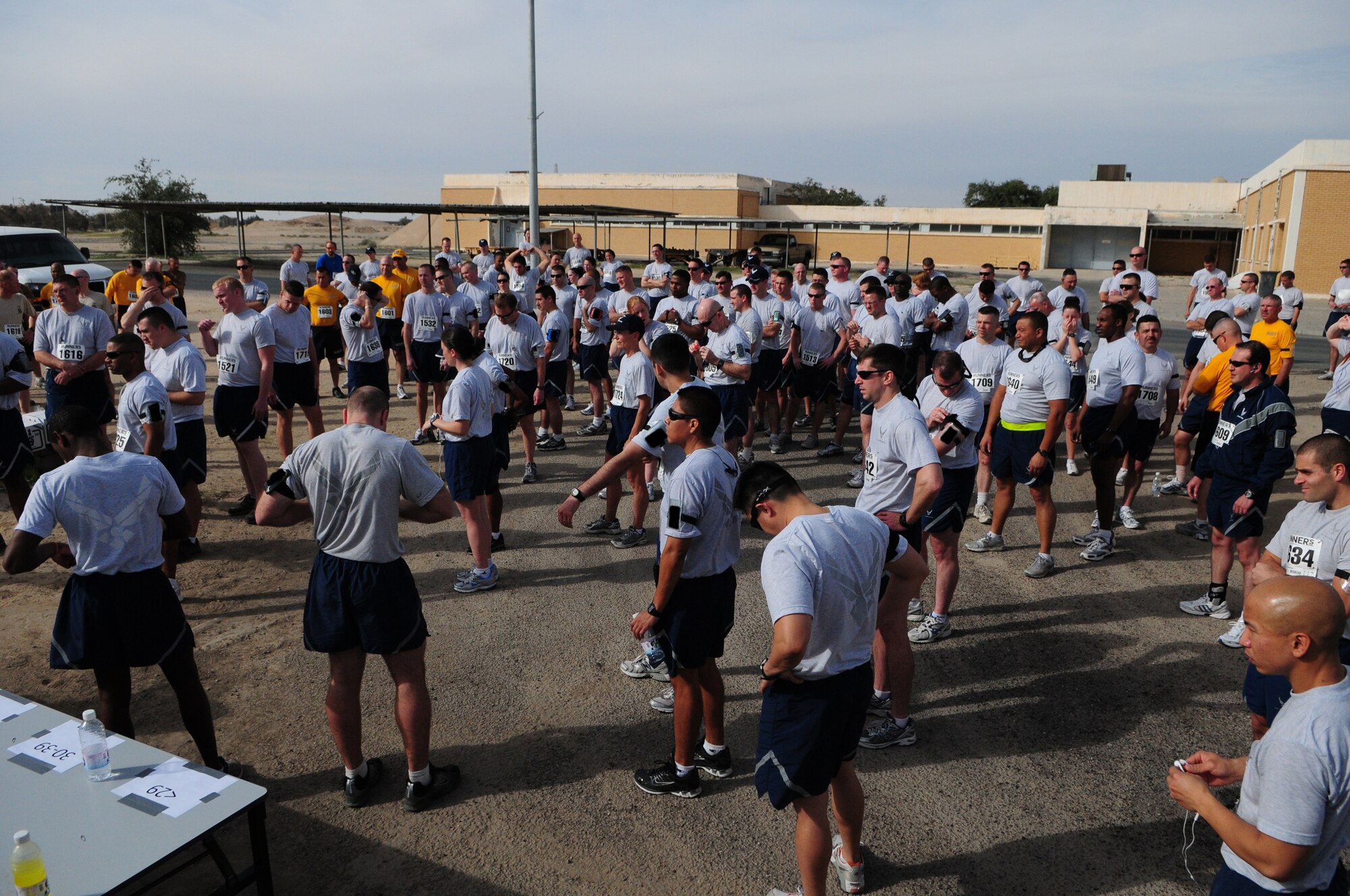 Armed Forces MLK run participants gather before the start of the event Jan. 18, 2010 at an air base in Southwest Asia. About 150 servicemembers, Department of Defense civilian and contract personnel and coalition partners participated in the 10- and 5-kilometer race honoring Martin Luther King Jr. The event was sponsored by HFP Racing. (U.S. Air Force photo by Staff Sgt. Robert Sizelove/Released)