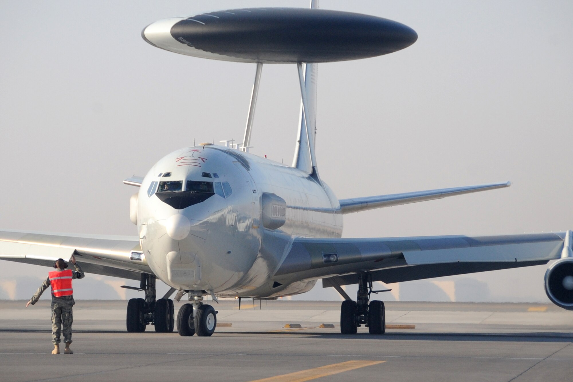 A E-3 Sentry Airborne Warning and Control System aircraft taxis out to the runway at an undisclosed location in Southwest Asia on Jan. 16.The E-3 Sentry is a modified Boeing 707/320 commercial airframe with a rotating radar dome that provides situational awareness of friendly, neutral and hostile activity, command and control of an area of responsibility, battle management of theater forces, all-altitude and all-weather surveillance of the battle space, and early warning of enemy actions during joint, allied, and coalition operations. (U.S. Air Force photo/Senior Airman Jenifer H. Calhoun/Released)

