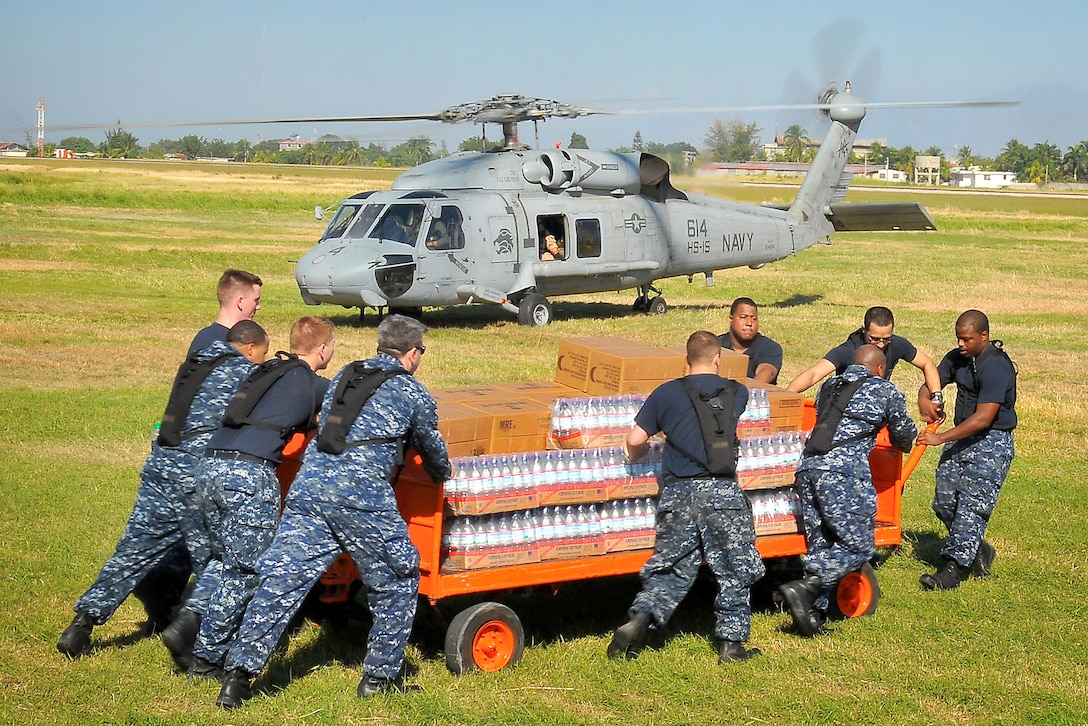 U.S. Navy sailors from the aircraft carrier USS Carl Vinson load water into an SH-60F Sea Hawk helicopter during humanitarian relief efforts in Port-au-Prince, Haiti, Jan. 18, 2010. The Carl Vinson and Carrier Air Wing 17 are conducting humanitarian and disaster relief operations as part of Operation Unified Response after a 7.0 magnitude earthquake caused severe damage near Port-au-Prince on Jan. 12, 2010.