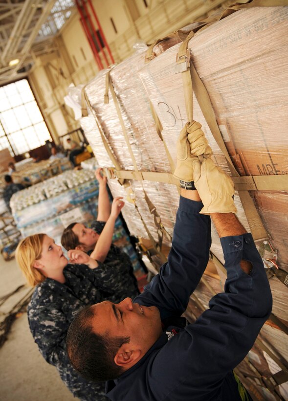 U.S. Navy Petty Officer 2nd Class Carlos AgostoBaez, front, and Seamen
