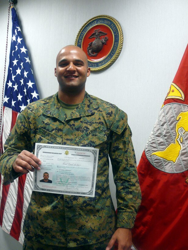 Headquarters Battalion administrative chief Staff Sgt. Angel C. DeJesus proudly displays his Certificate of Naturalization, which he received after officially becoming an American citizen Dec. 18, 2009. Raised in Consuelo, Dominican Republic, the 29-year-old Atlanta denizen moved to the U.S. when he was 14.