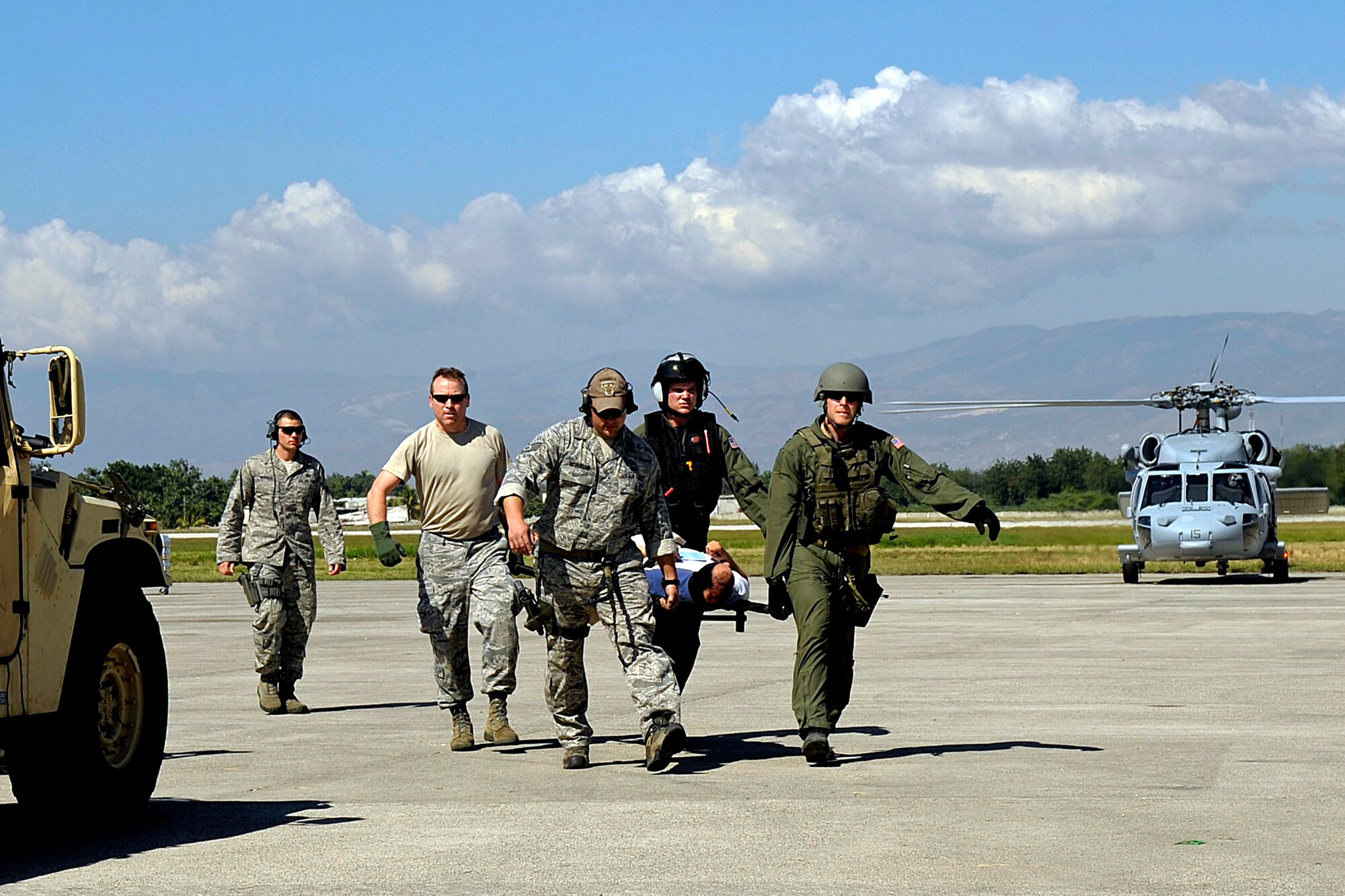 Airmen from the Air Force Special Operations Command at Hurlburt Field, Fla., offload injured people in Port-au-Prince, Haiti, Jan. 15, 2010. (U.S. Air Force photo/Master Sgt. Russell E. Cooley IV)