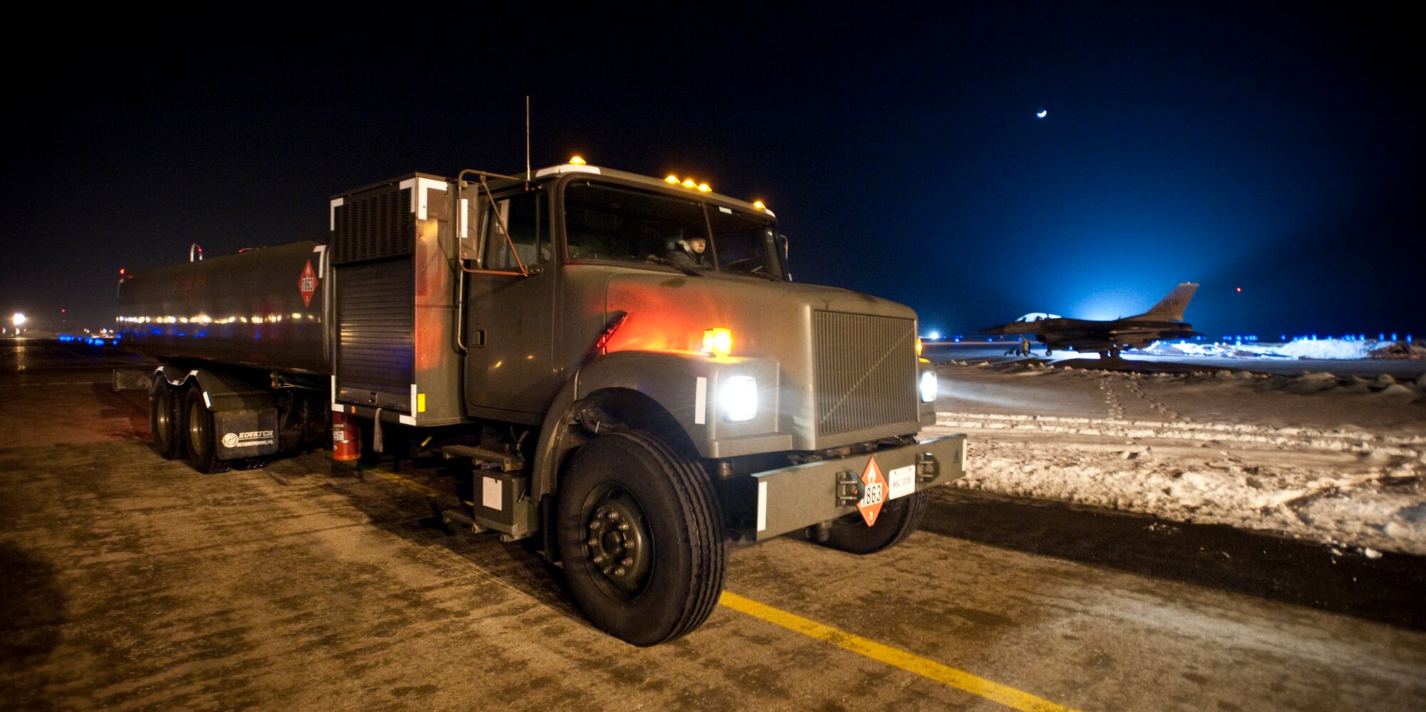 MISAWA AIR BASE, Japan -- An R-11 fuel truck carrying JP-8 jet fuel pulls up in front of a hardened aircraft shelter to refuel an F-16 Fighting Falcon Jan. 19. The 35th Logistics Readiness Squadron fuels management flight ensures 35th Fighter Wing and transient aircraft receive fuel 24 hours a day, seven days a week.  (U.S. Air Force photo/Staff Sgt. Samuel Morse)