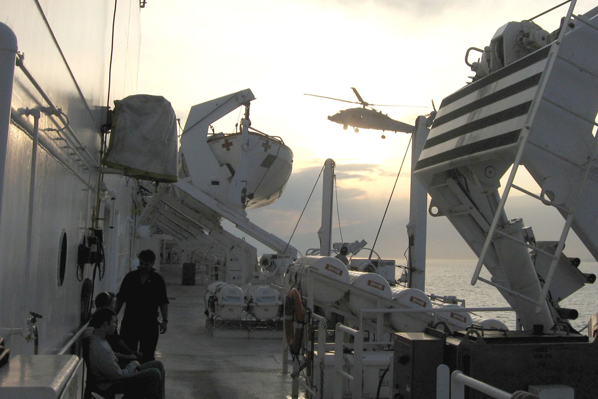 A Navy helicopter readies to land aboard the hospital ship USNS Comfort as it anchors Jan. 20, 2010 in Port-au-Prince harbor, Haiti. The ship deployed to assist in relief efforts following a Jan. 12 magnitude 7 earthquake that devastated the island nation. (Department of Defense photo/Jim Garamone) 
